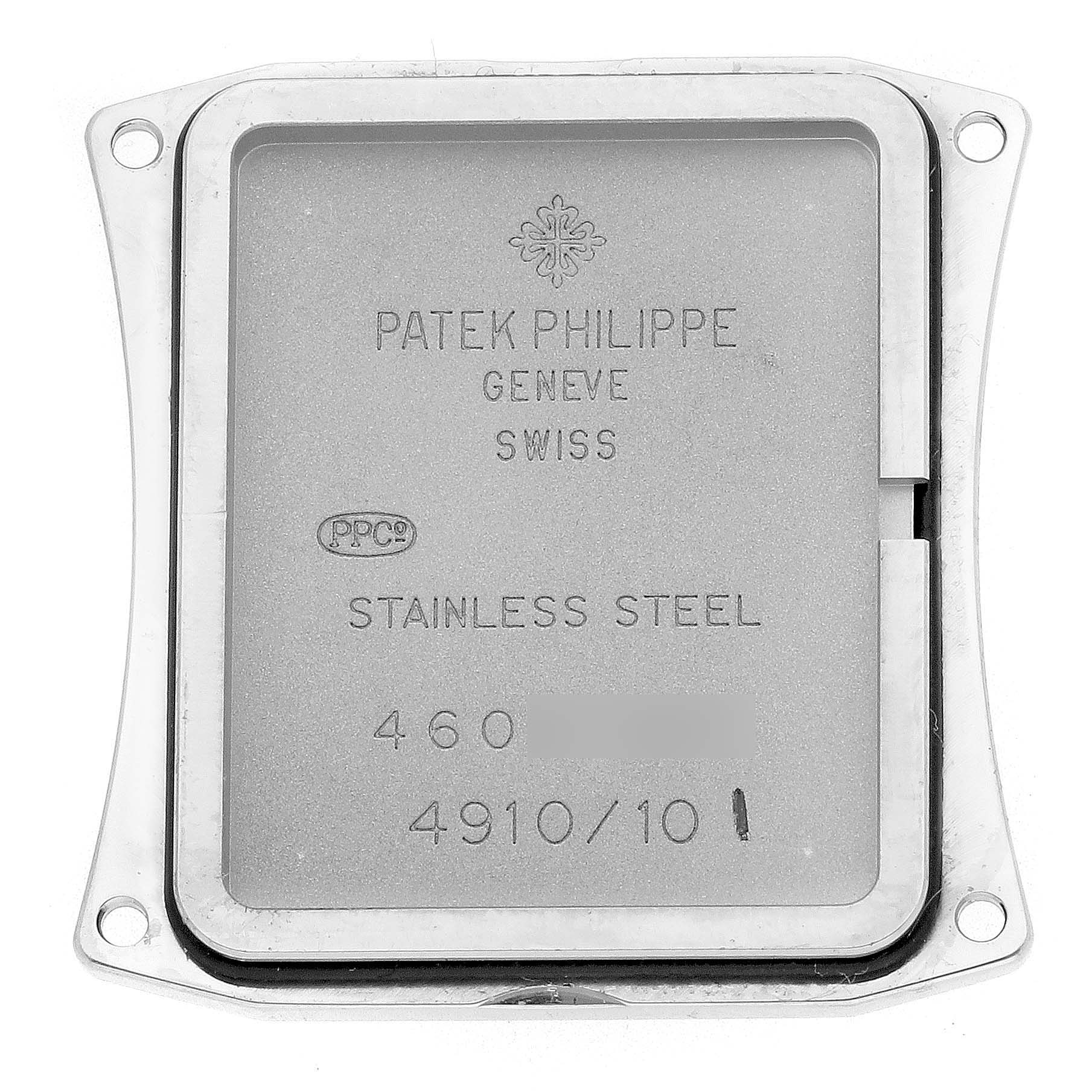 The image shows the back case of a Patek Philippe Twenty-4 4910/10A-010 Women's Stainless Steel Silver Dial watch, displaying engraved details and holes for screws.