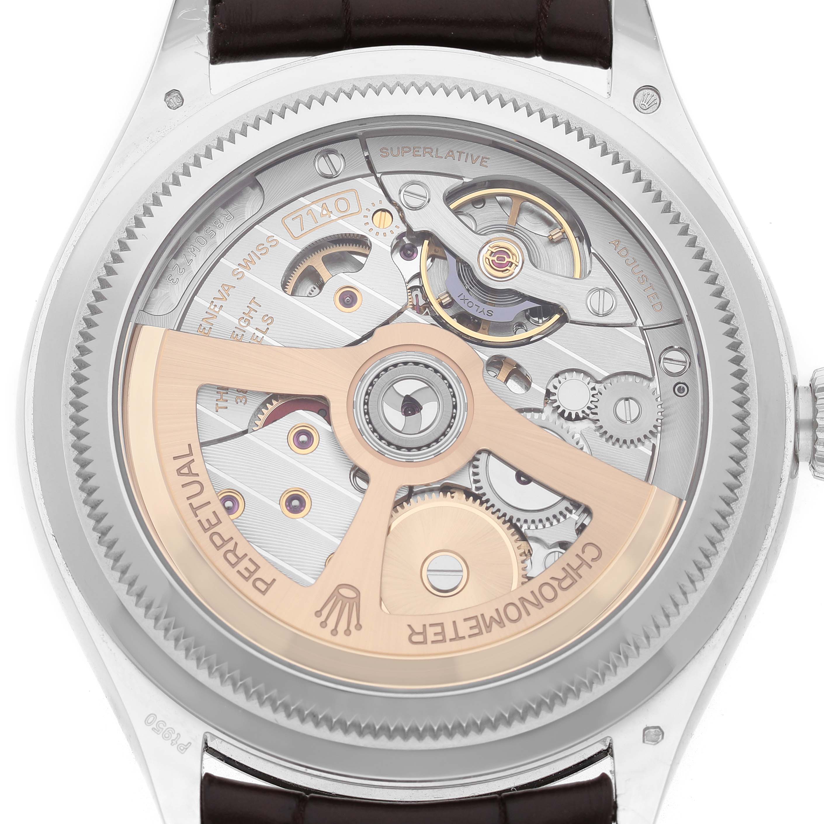 The image shows the back view of a Rolex 1908 52506 Men's Platinum Blue Dial model, showcasing its intricate mechanical movement and rotor.