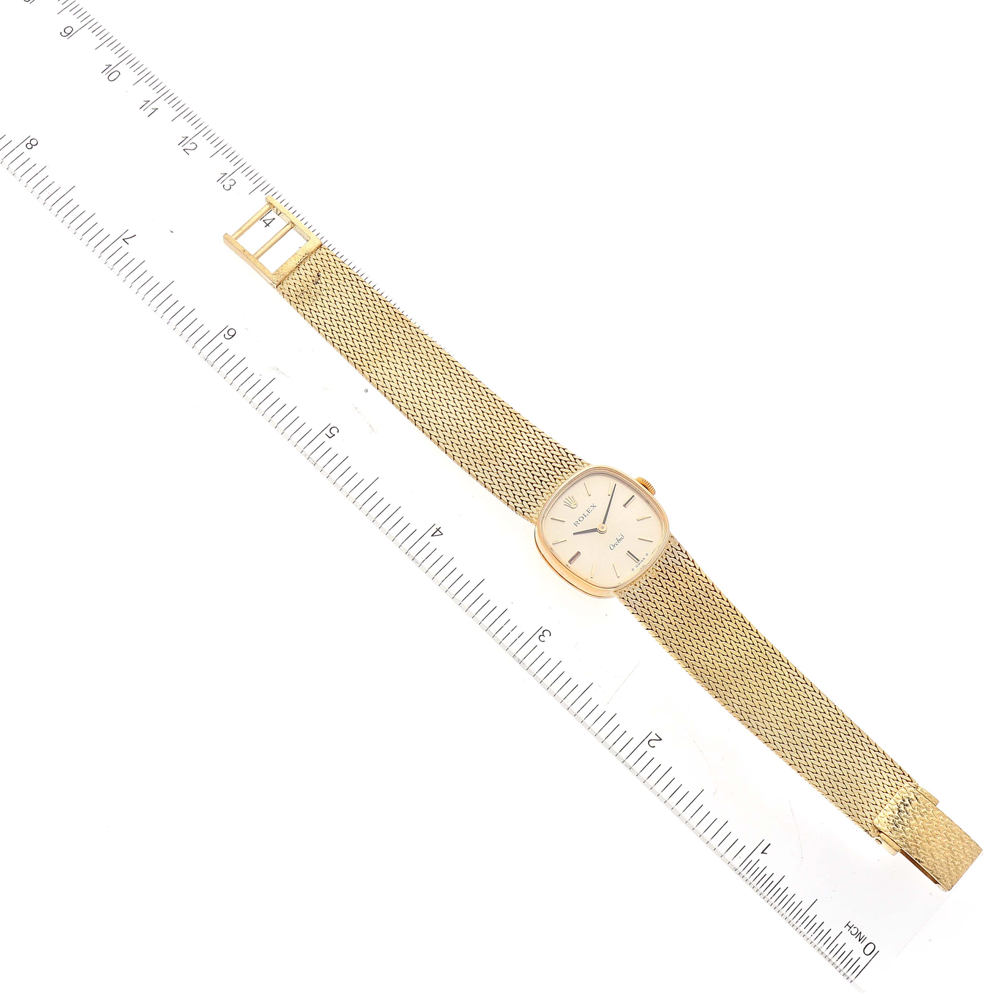 The image shows a Rolex Cocktail 2672 Women's Yellow Gold Silver Dial 2672 Women's Yellow Gold Silver Dial model watch laid flat beside a ruler, visible at a top-down angle.