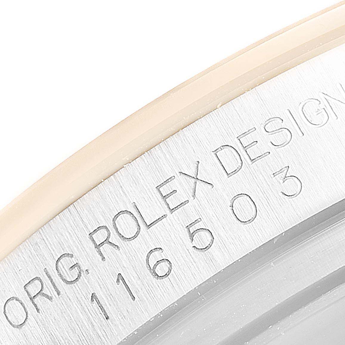 This close-up image shows the serial engraving on the case of a Rolex Daytona 116503 Men's Steel and Gold (two tone) Champagne Dial 116503 Men's Steel and Gold (two tone) Champagne Dial watch.