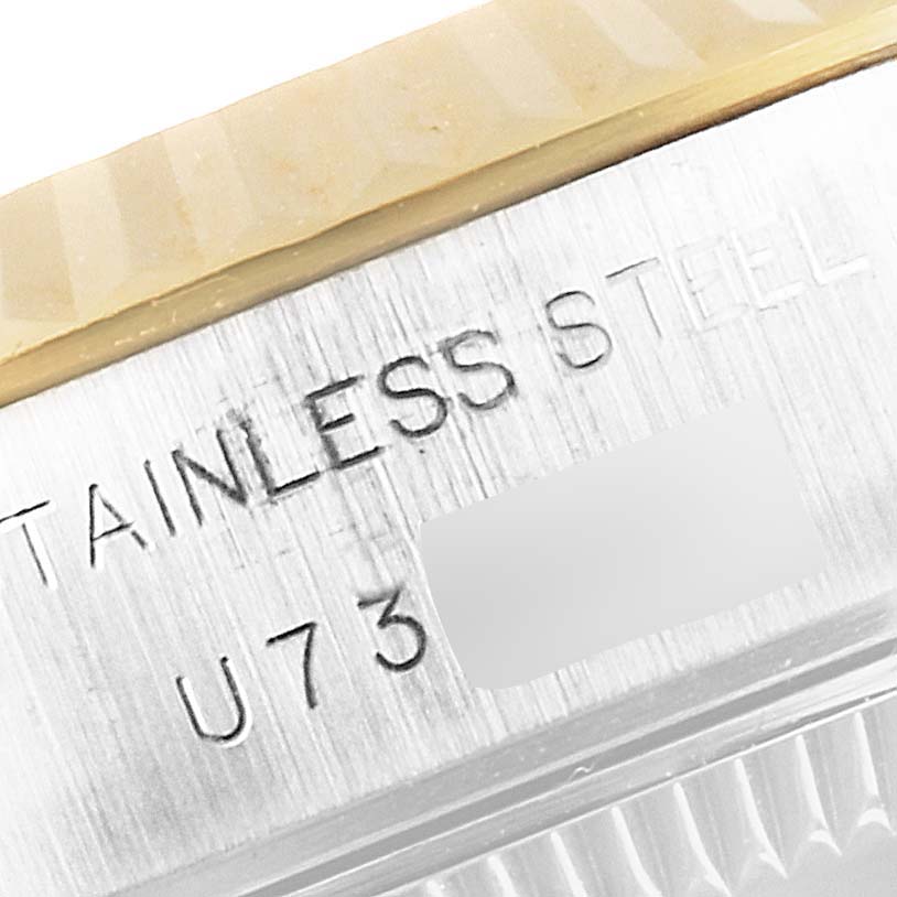 This is a close-up image of the Rolex Datejust 69173 Women's Steel and Gold (two tone) Champagne Dial 69173 Women's Steel and Gold (two tone) Champagne Dial watch's case, showing part of the bezel and engraved "STAINLESS STEEL" text.