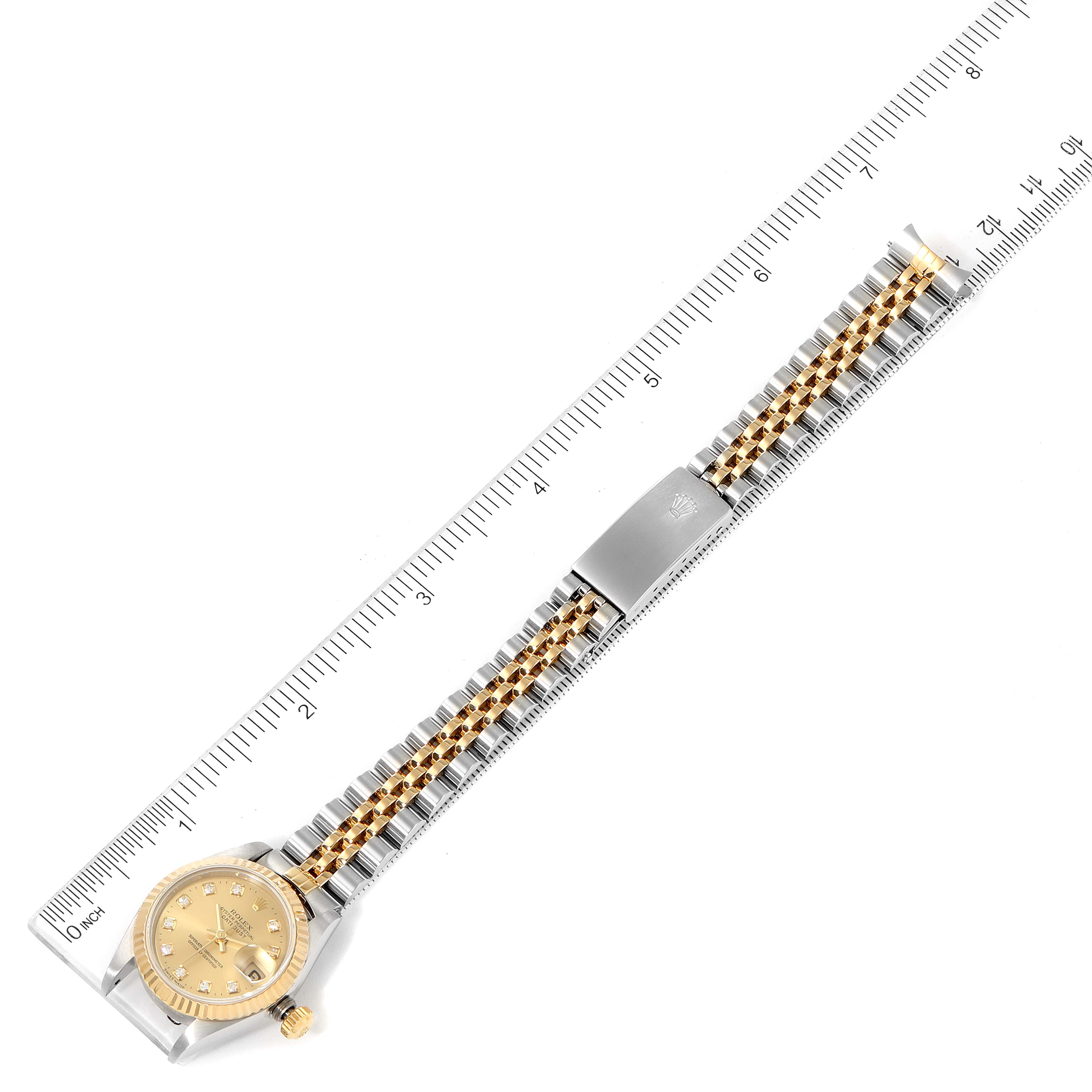 The image shows the Rolex Datejust 69173 Women's Steel and Gold (two tone) Champagne Dial 69173 Women's Steel and Gold (two tone) Champagne Dial watch laid flat with its entire bracelet and clasp visible, alongside a ruler for scale.