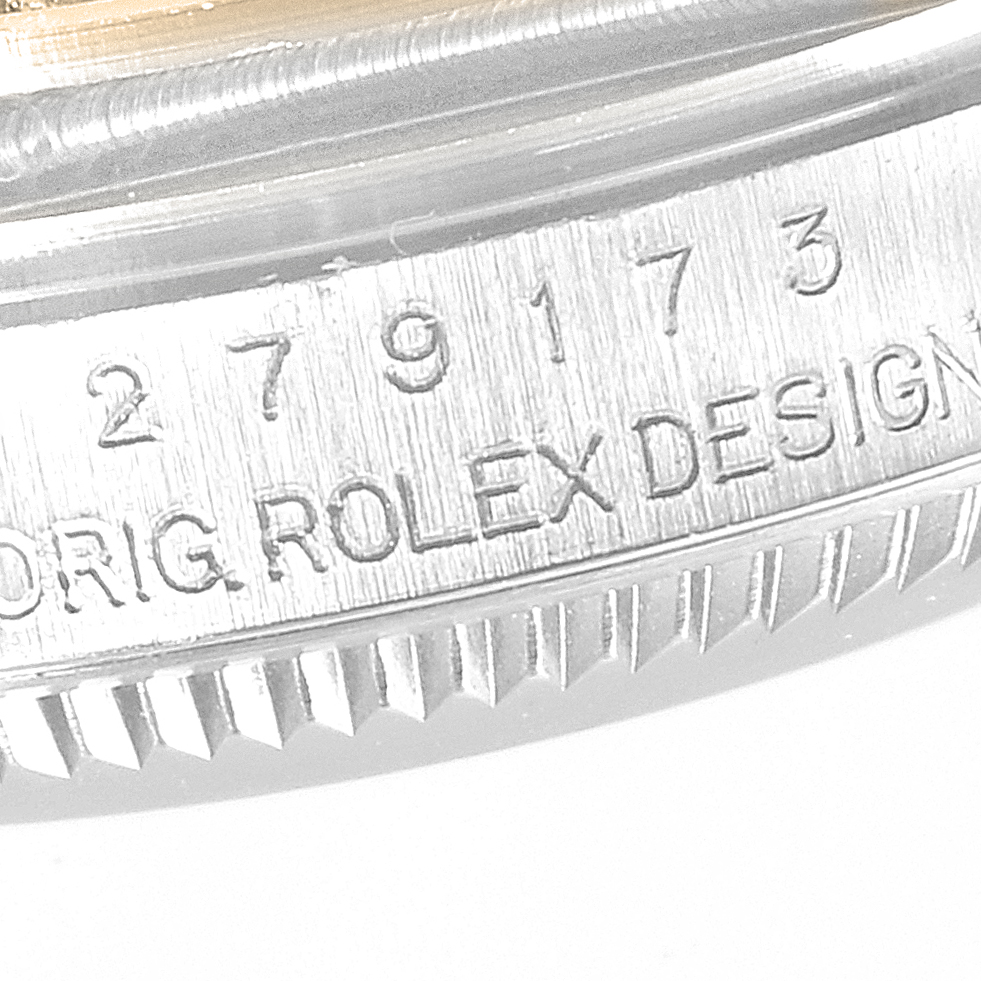 The image shows the side view of a Rolex Datejust 279173 Womens Steel and Gold (two tone) Champagne Dial watch, highlighting the engraved model details on the case.