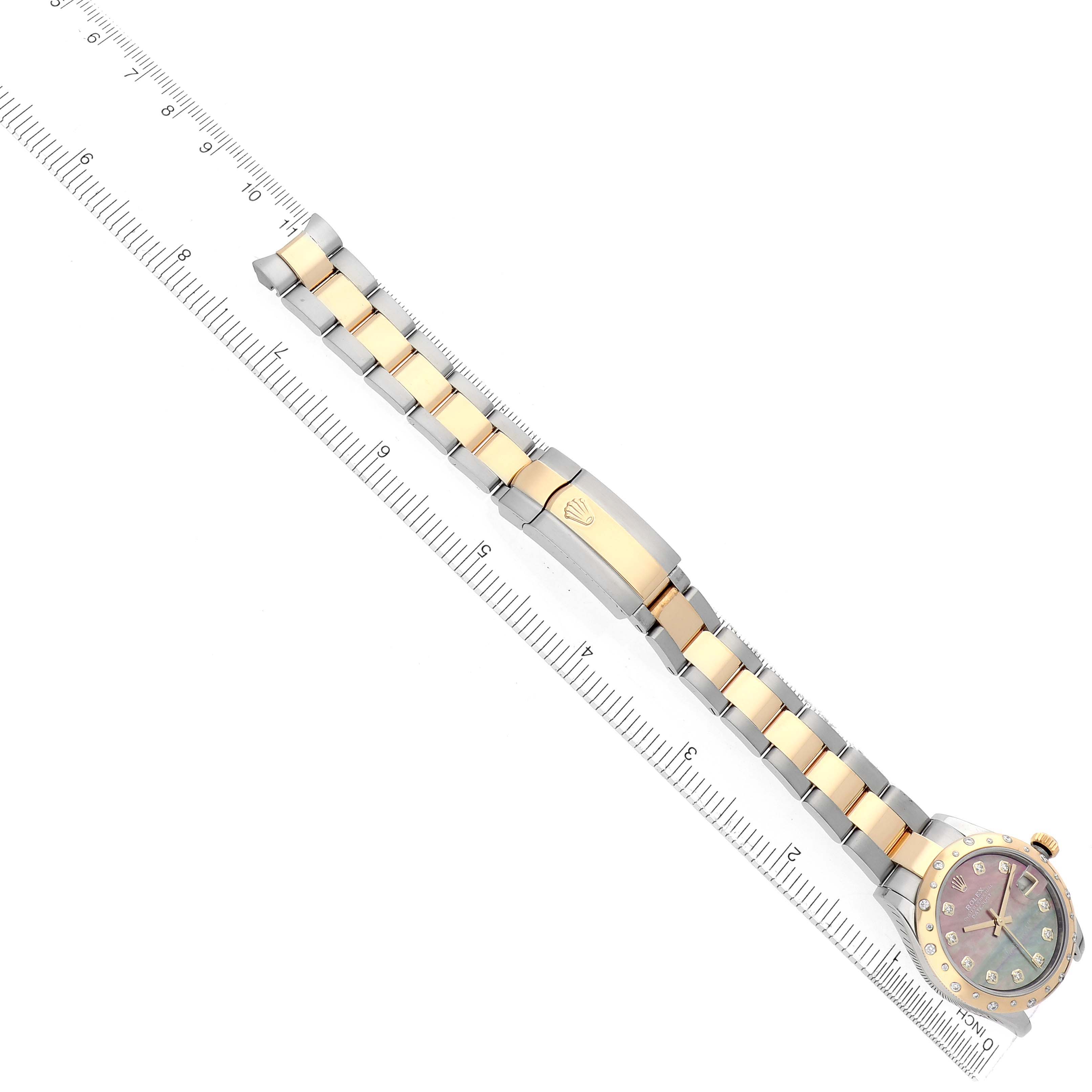 The Rolex Datejust 278343 Women's Steel and Gold (two tone) Mother of Pearl Dial watch is shown from a top-down angle, highlighting its bracelet, clasp, and partially visible dial.