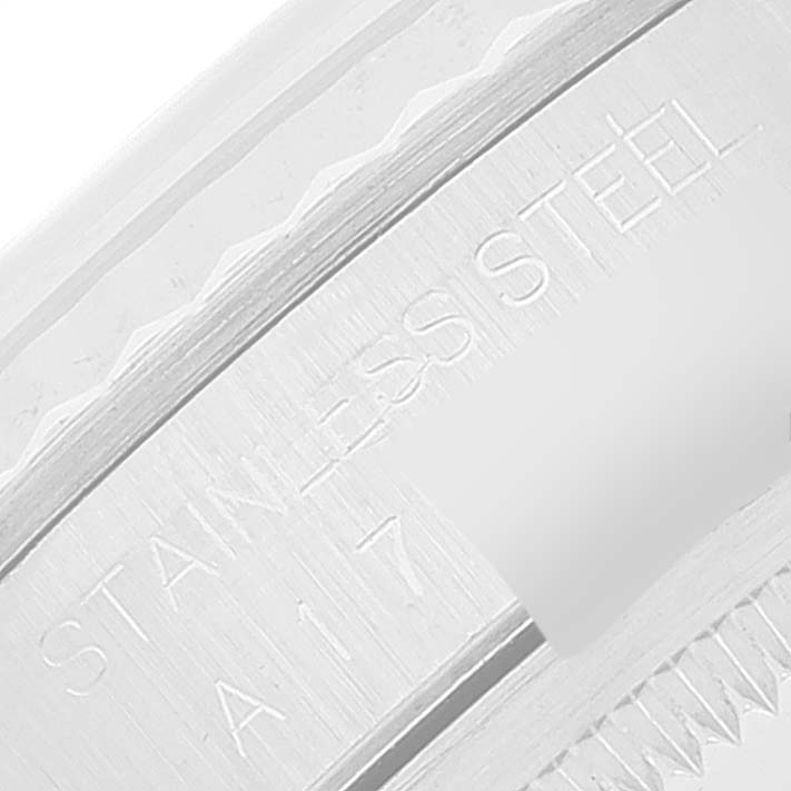 This close-up image of a Rolex Datejust 16234 Men's Stainless Steel Silver Dial 16234 Men's Stainless Steel Silver Dial watch shows a section of the stainless steel case with engraved text.
