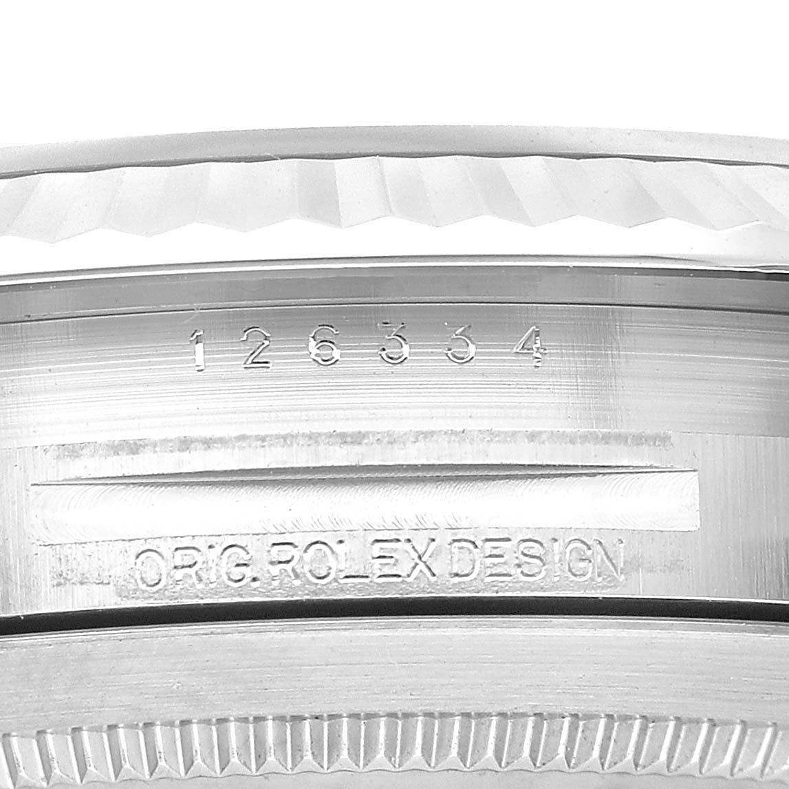 The image shows a close-up of the side and serial number of a Rolex Datejust 41 126334 Men's Stainless Steel Blue Dial, highlighting the bezel and engravings.