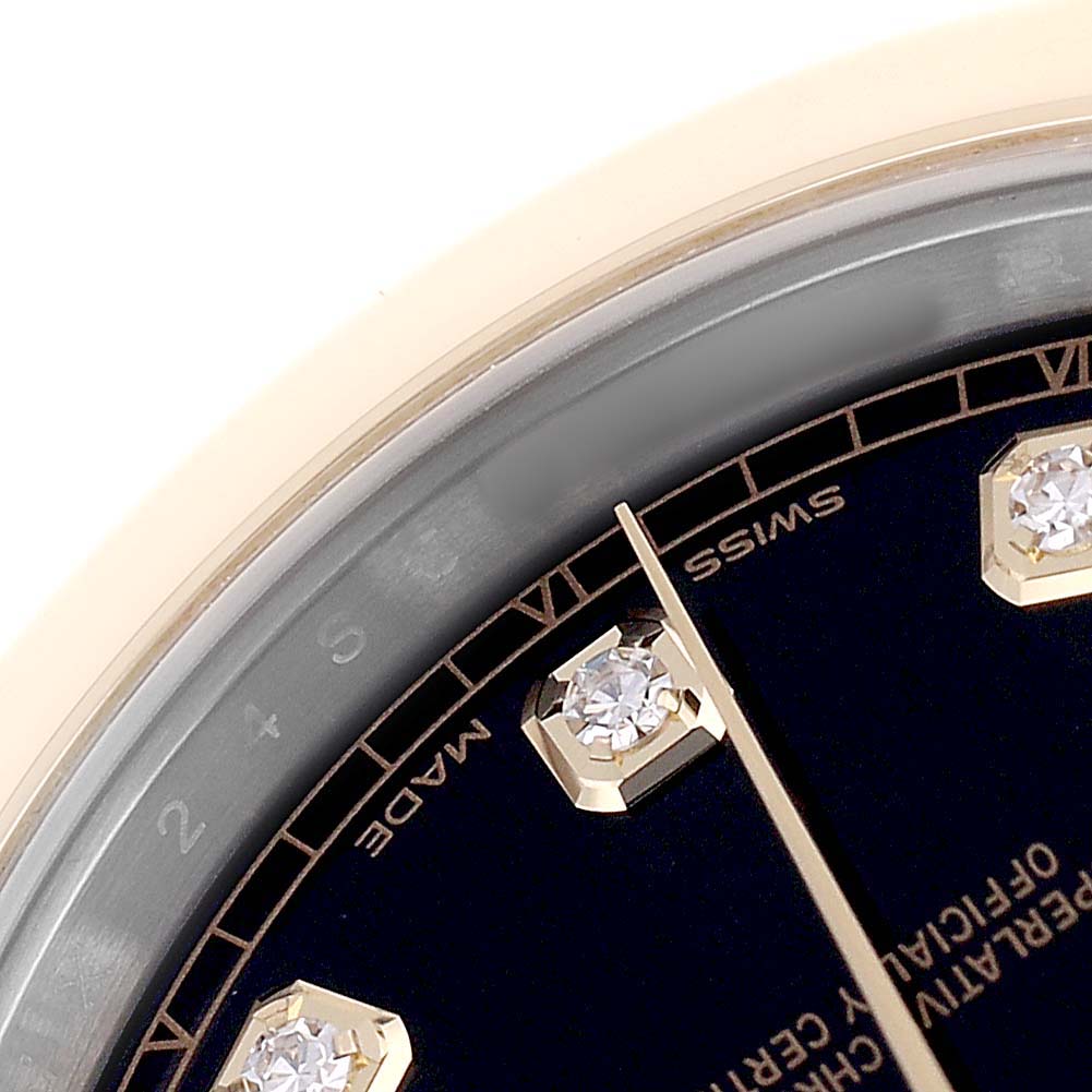 The image shows a close-up of the dial and hour markers of a Rolex Datejust 41 126303 Men's Steel and Gold (two tone) Black Dial watch, focusing on the Swiss-made text and diamond indices.