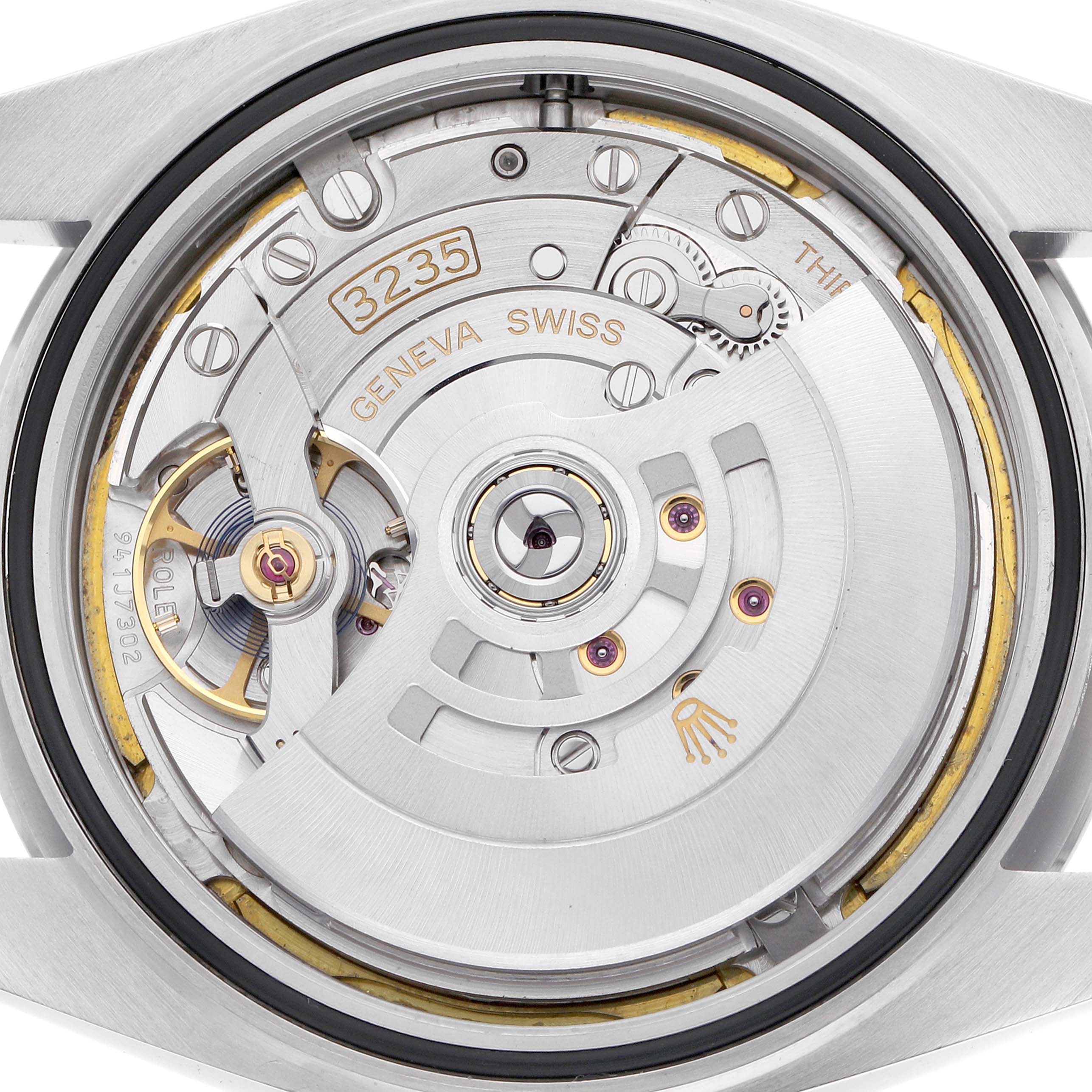 The image shows the Rolex Datejust 126300 Men
s Stainless Steel White Dial
s movement with an overhead view focusing on the rotor and internal components.