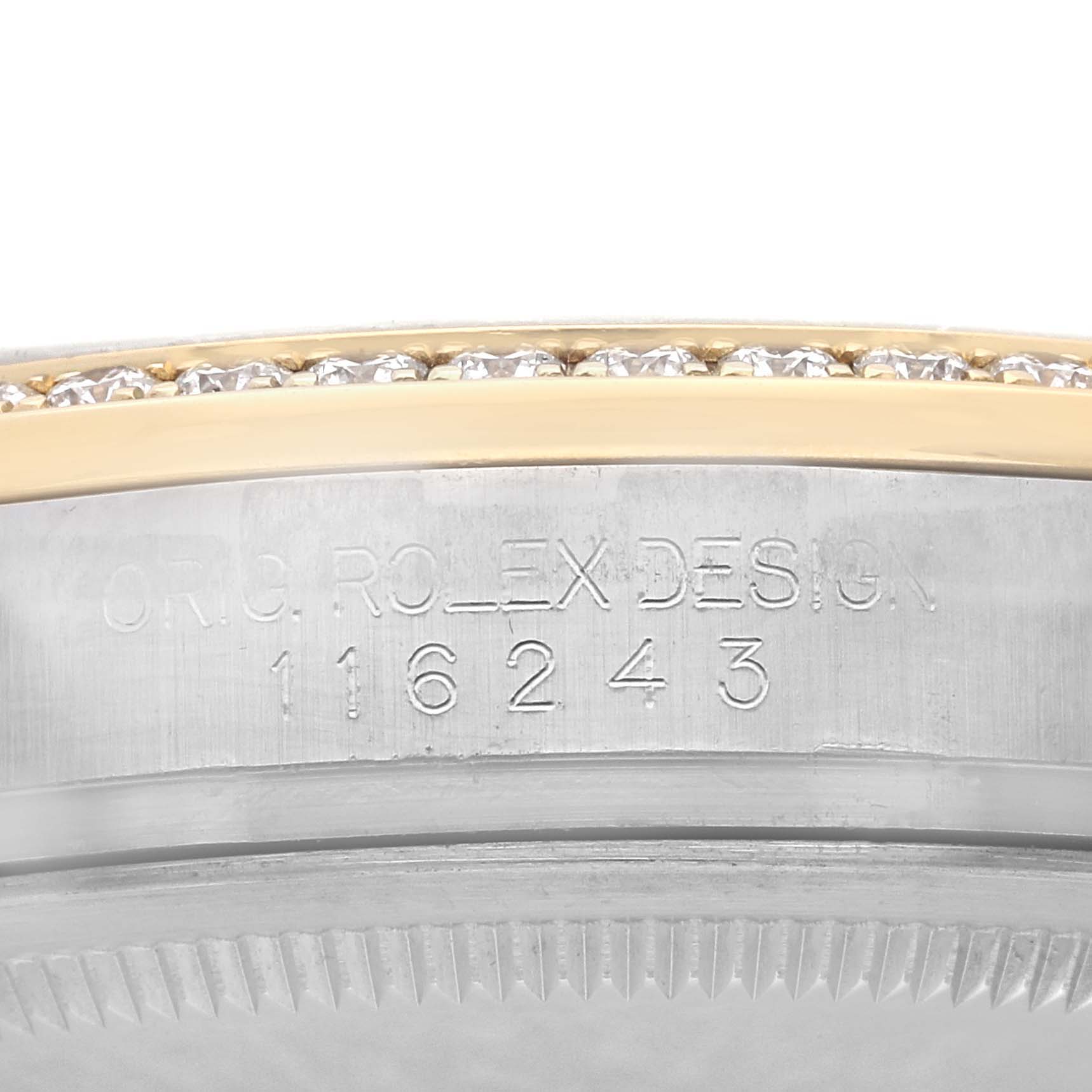 The image shows a close-up of a Rolex Datejust 116243 Men's Steel and Gold (two tone) Black Dial watch, highlighting the engraved design number and a diamond-set bezel edge.
