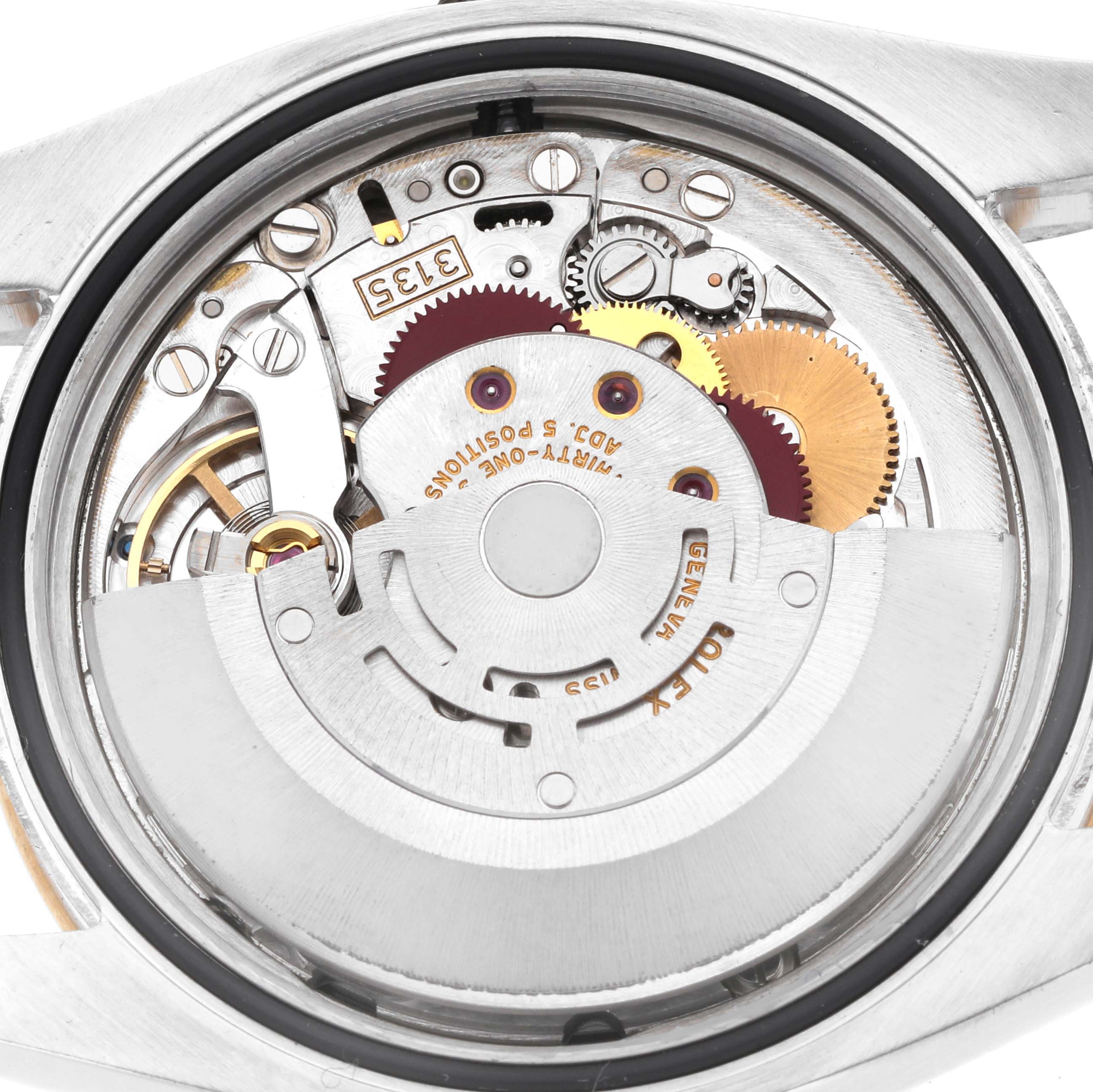 The image shows the movement of a Rolex Datejust 116243 Men's Steel and Gold (two tone) Black Dial, highlighting gears and components from a rear angle.