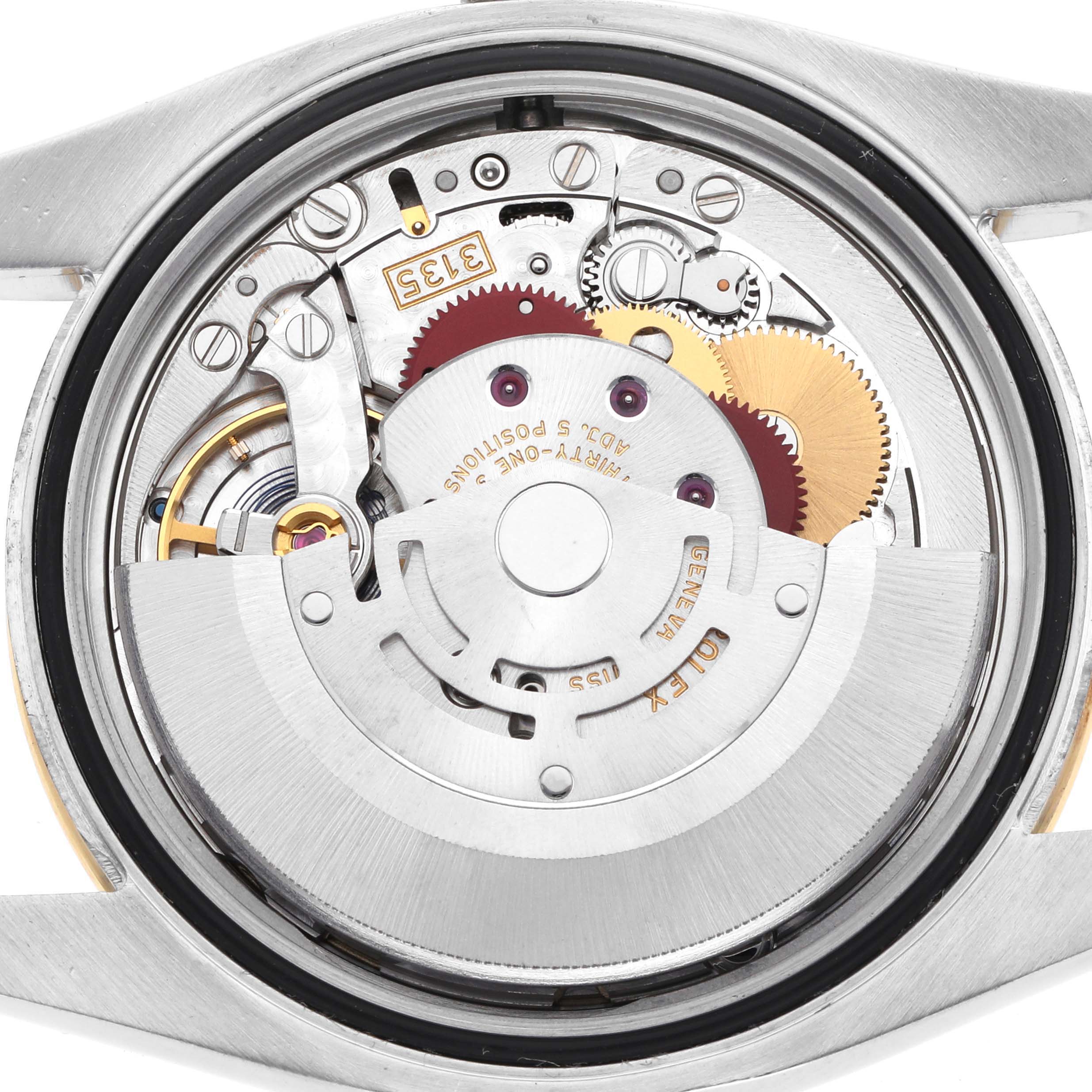 This image shows the movement of a Rolex Datejust 116243 Men
s Steel and Gold (two tone) Champagne Dial watch from the back, highlighting gears and mechanisms.