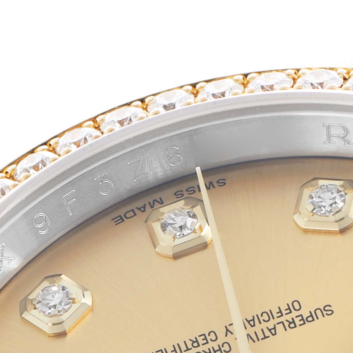 The image shows a close-up of the dial edge and diamond bezel of a Rolex Datejust 116243 Men
s Steel and Gold (two tone) Champagne Dial watch.