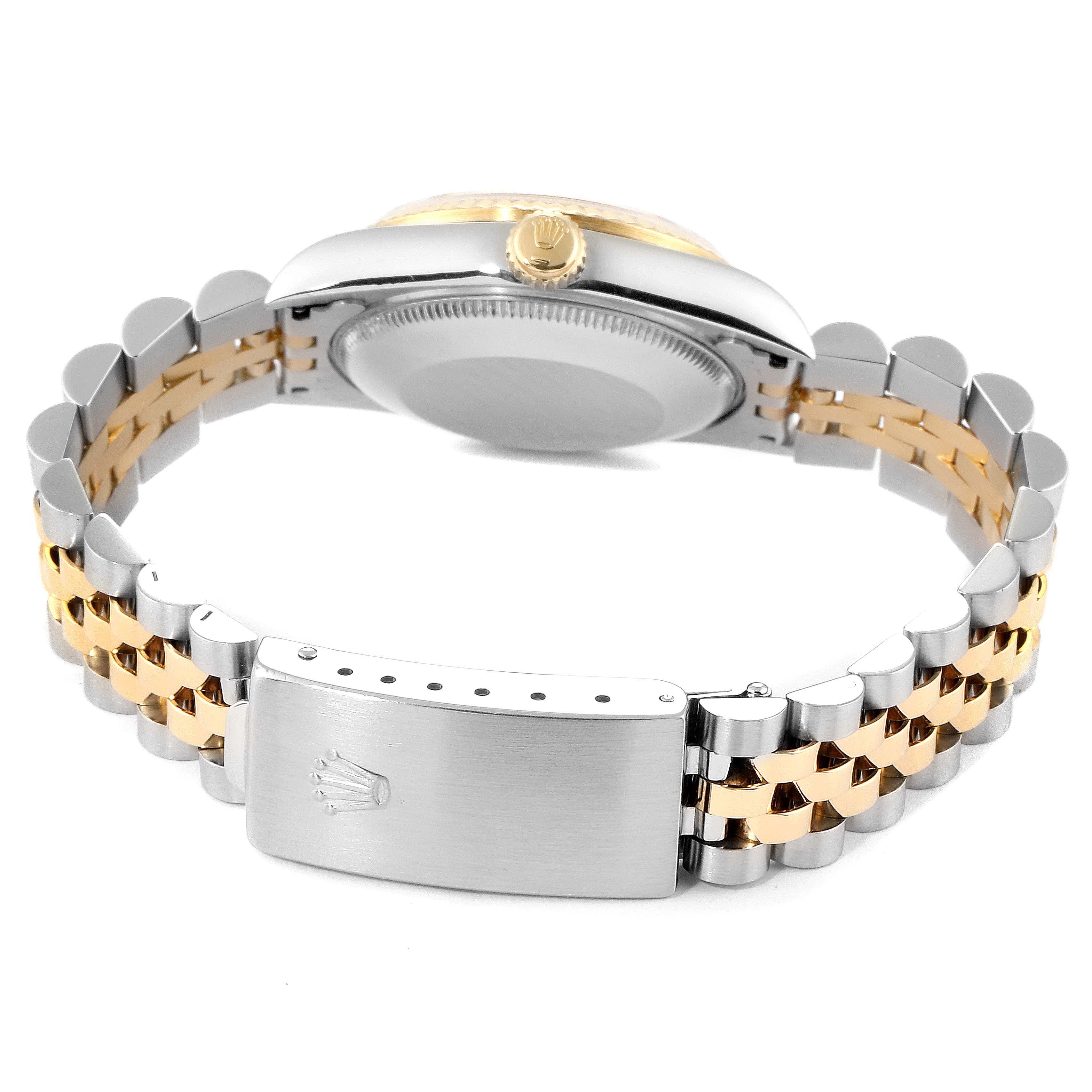 The image shows the back view and bracelet of a Mid-Size Rolex watch, highlighting the clasp and crown side.