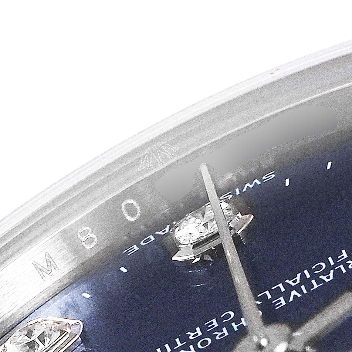 This close-up of a Rolex Mid-Size 178274 Women
s Stainless Steel Blue Dial 178274 Women
s Stainless Steel Blue Dial model shows the watch
s dial, diamond marker, and partial hand against the bezel
s inner edge.