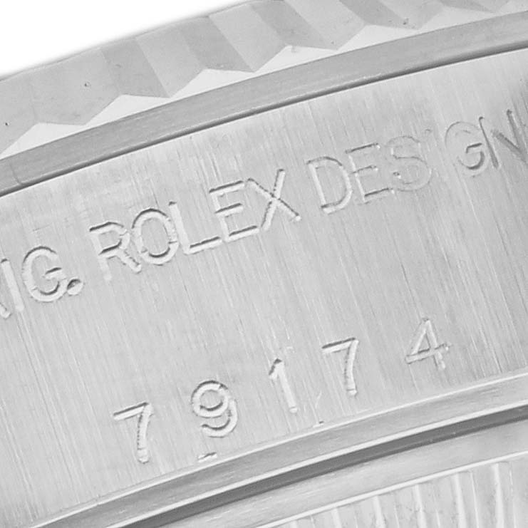 The image shows a close-up angle of the Rolex Datejust 79174 Women's Stainless Steel Pink Dial 79174 Women's Stainless Steel Pink Dial model's inner bezel with engraving.