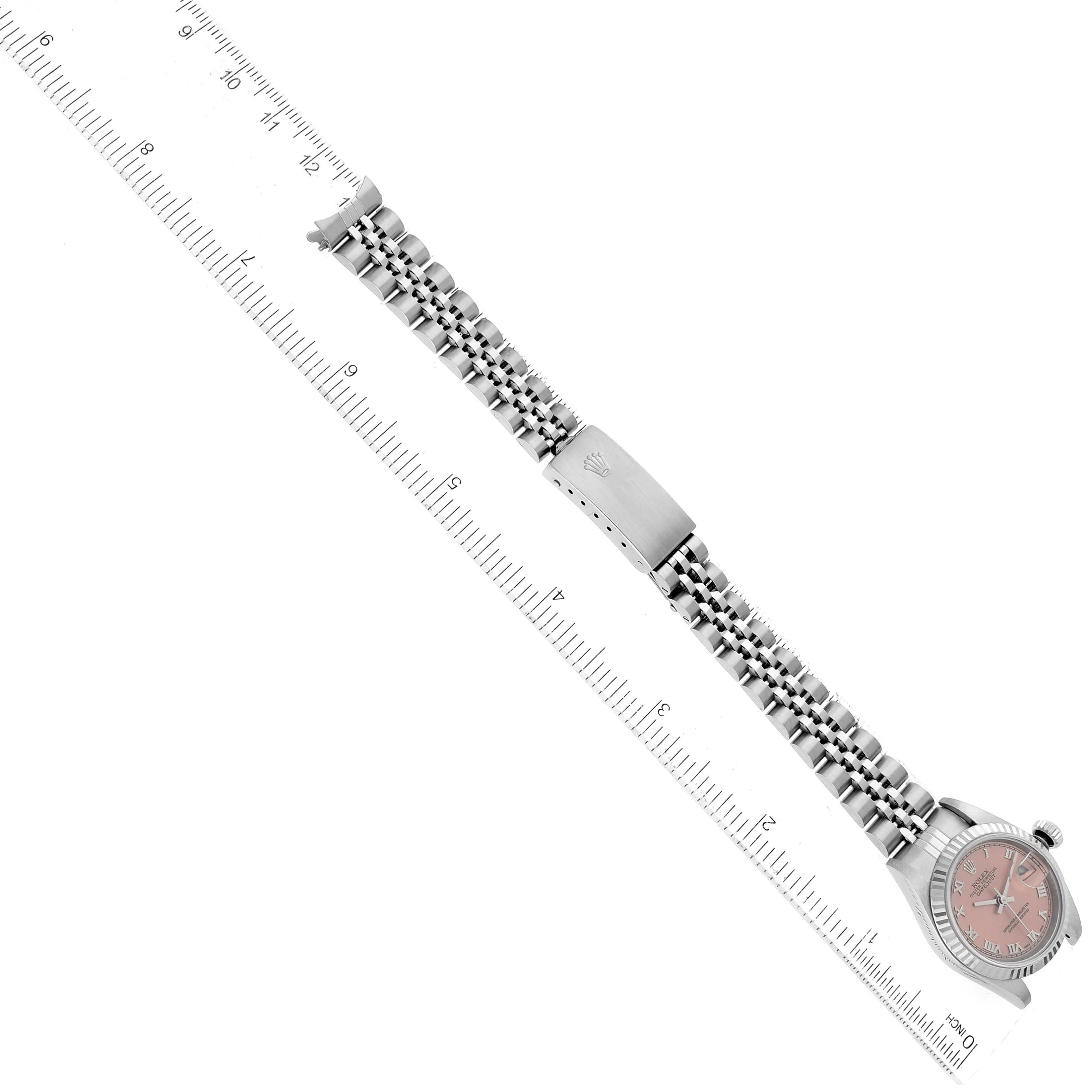 The image shows a Rolex Datejust 79174 Women's Stainless Steel Pink Dial 79174 Women's Stainless Steel Pink Dial watch laid flat, highlighting the full bracelet and case, placed alongside a ruler.