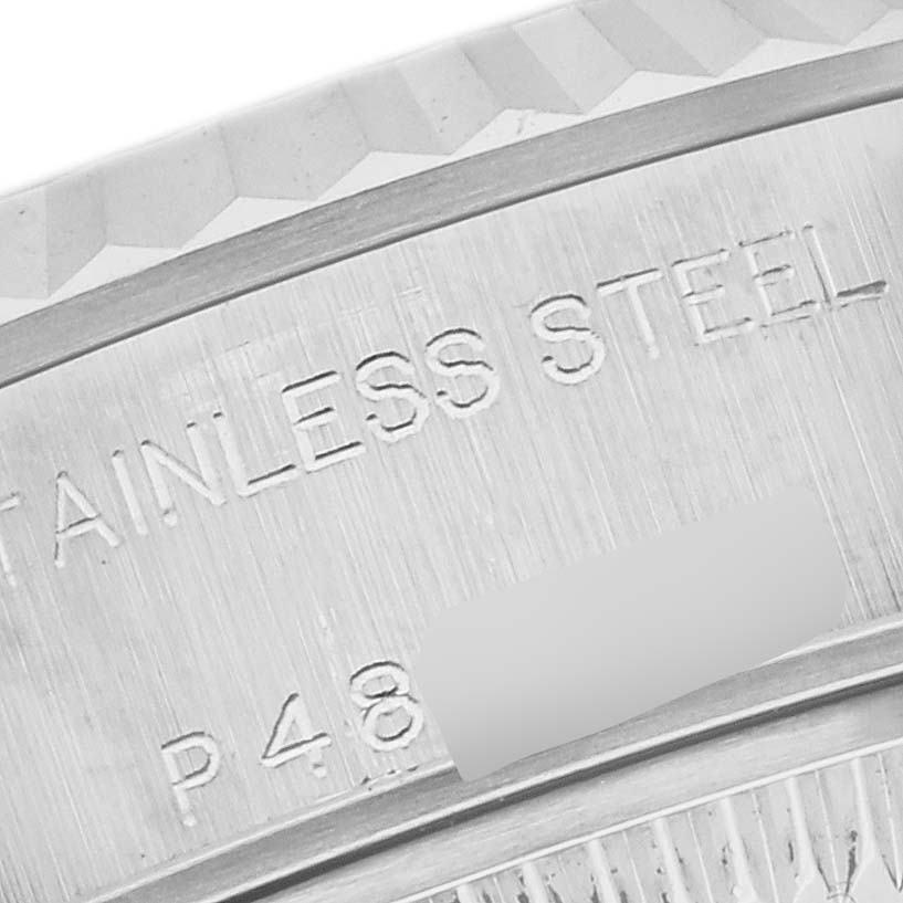 This image shows a close-up of the edge and engravings on the bezel of a Rolex Datejust 79174 Women's Stainless Steel Pink Dial 79174 Women's Stainless Steel Pink Dial watch, highlighting its stainless steel material.