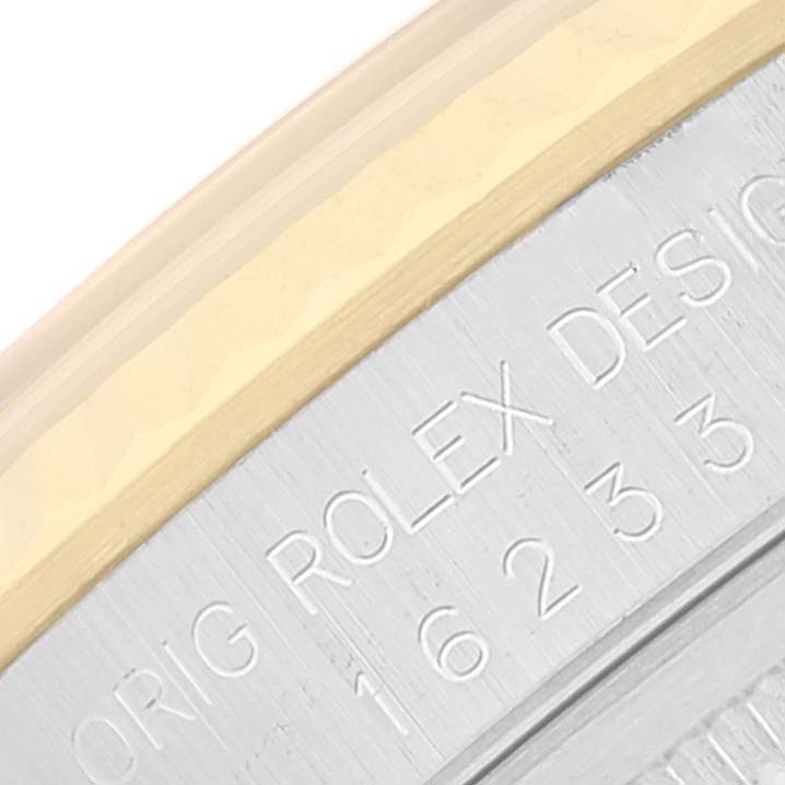 The image shows an angled close-up of the side of a Rolex Datejust 16233 Men's Steel and Gold (two tone) Champagne Dial 16233 Men's Steel and Gold (two tone) Champagne Dial watch, highlighting the bezel and engraved details.