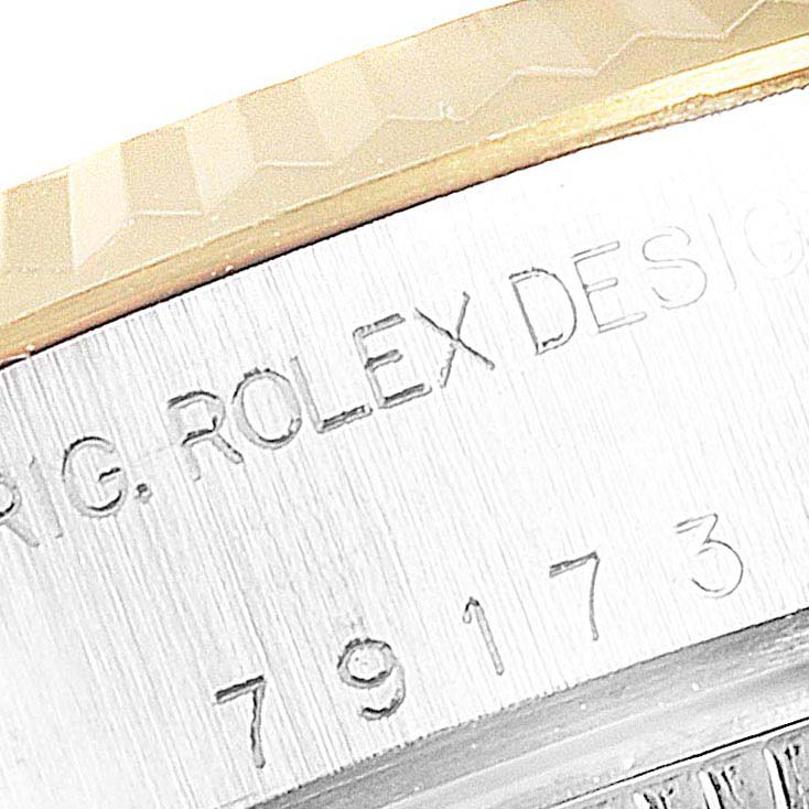 The image shows a close-up angle of the serial number and bezel of a Rolex Datejust 79173 Women's Steel and Gold (two tone) Blue Dial 79173 Women's Steel and Gold (two tone) Blue Dial watch.