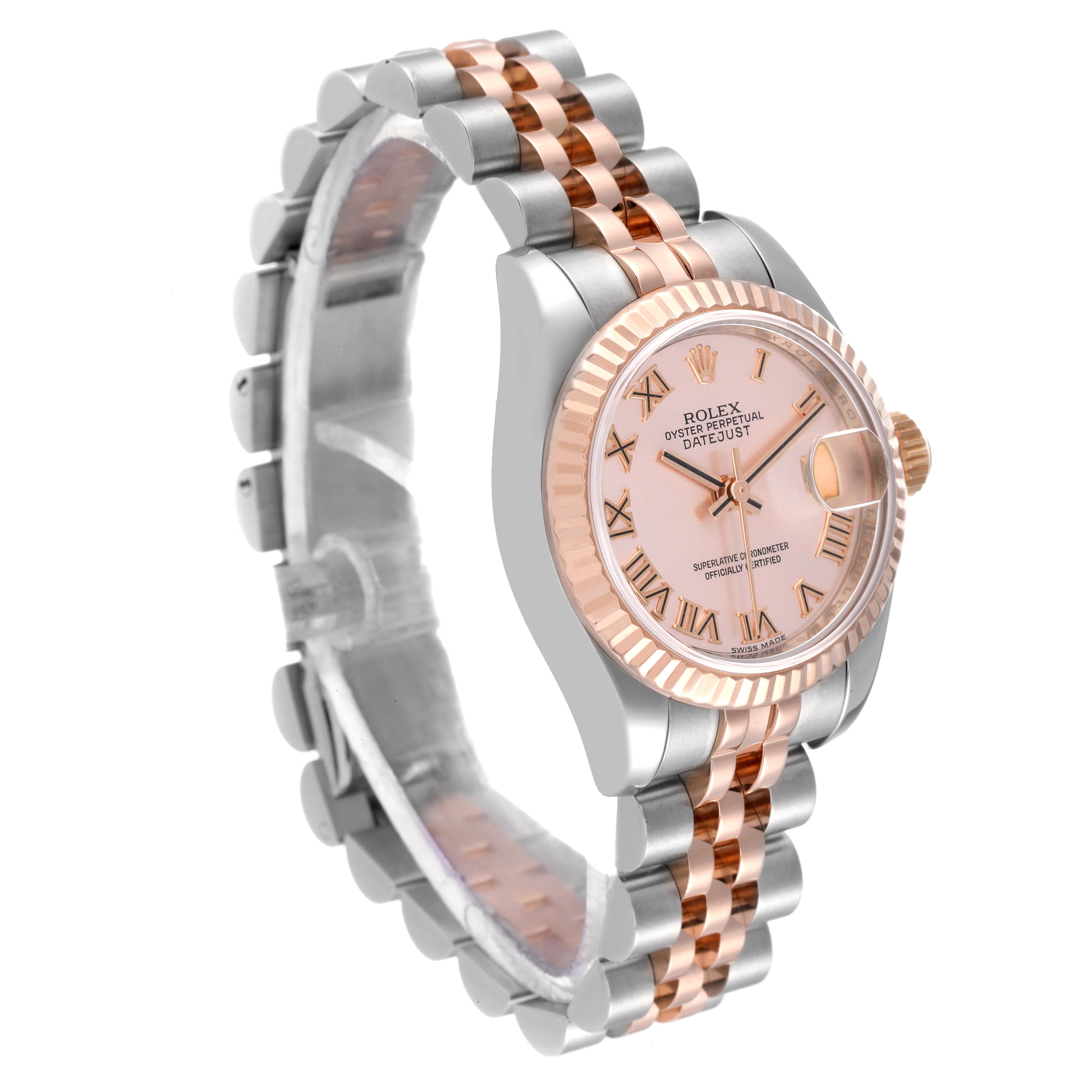 This image shows a Rolex Datejust 179171 Women's Steel and Gold (two tone) Pink Dial 179171 Women's Steel and Gold (two tone) Pink Dial watch from an angled front-side view, highlighting its face, fluted bezel, and two-tone bracelet.