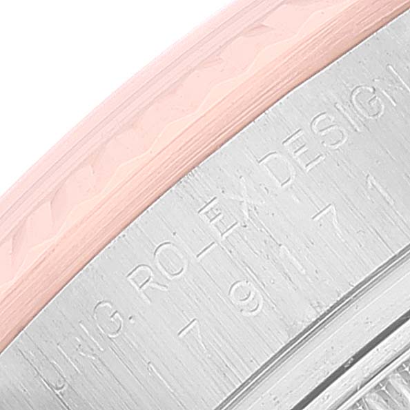 This close-up image of a Rolex Datejust 179171 Women's Steel and Gold (two tone) Pink Dial 179171 Women's Steel and Gold (two tone) Pink Dial watch shows part of the bezel and engraved text on the case.