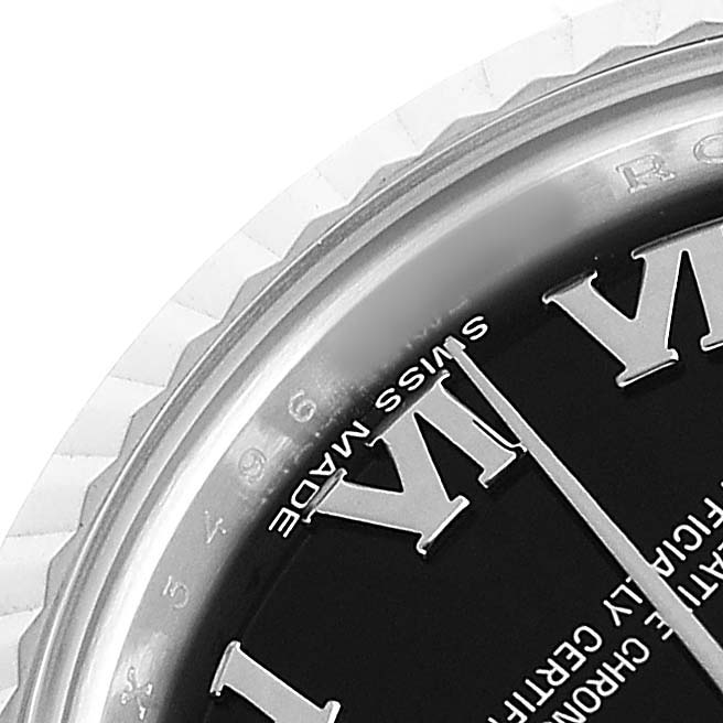 The image shows a close-up of the dial and bezel of a Rolex Datejust 179174 Women's Stainless Steel Black Dial watch, highlighting the Roman numeral markers.