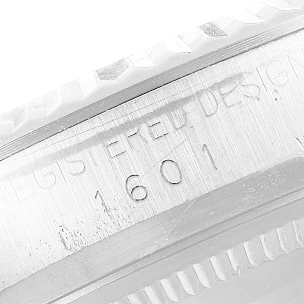 The image shows a close-up of the engraved model and serial number on the case of the Vintage Collection Rolex watch, model 1601.