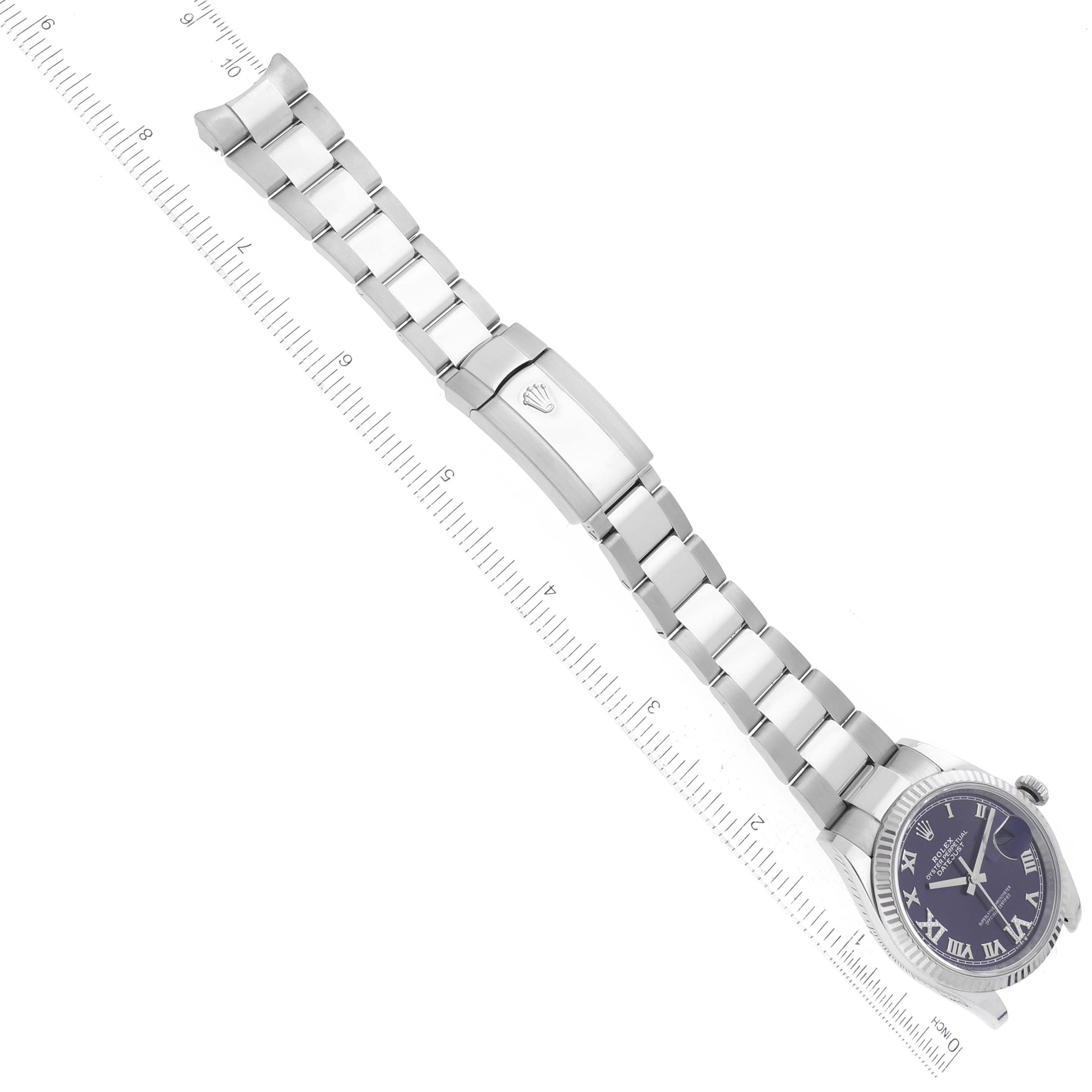 The image shows a Rolex Datejust 126234 Men's Stainless Steel Purple Dial 126234 Men's Stainless Steel Purple Dial watch laid out flat with its metal bracelet and clasp visible alongside a measuring ruler.