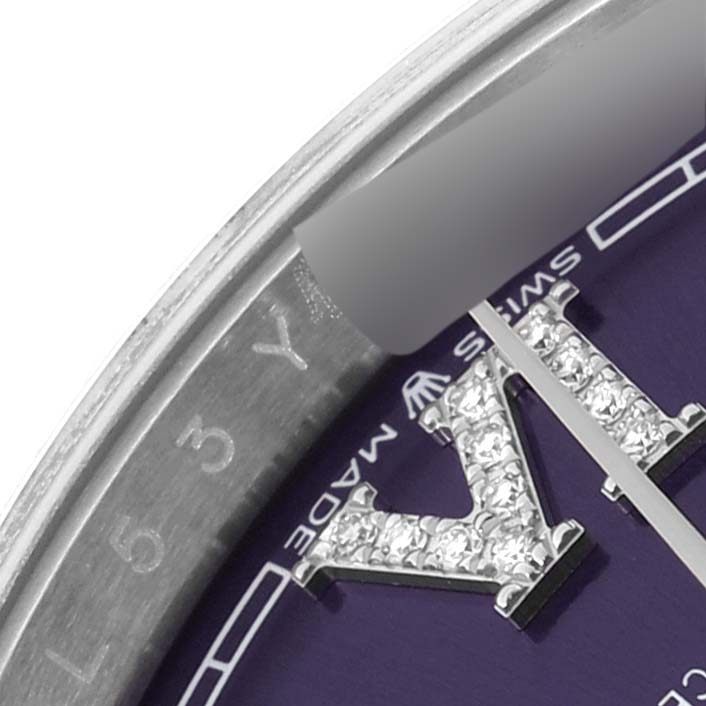 This close-up image of the Rolex Datejust 126234 Men's Stainless Steel Purple Dial 126234 Men's Stainless Steel Purple Dial watch shows part of the dial, bezel, and diamond-set roman numerals.