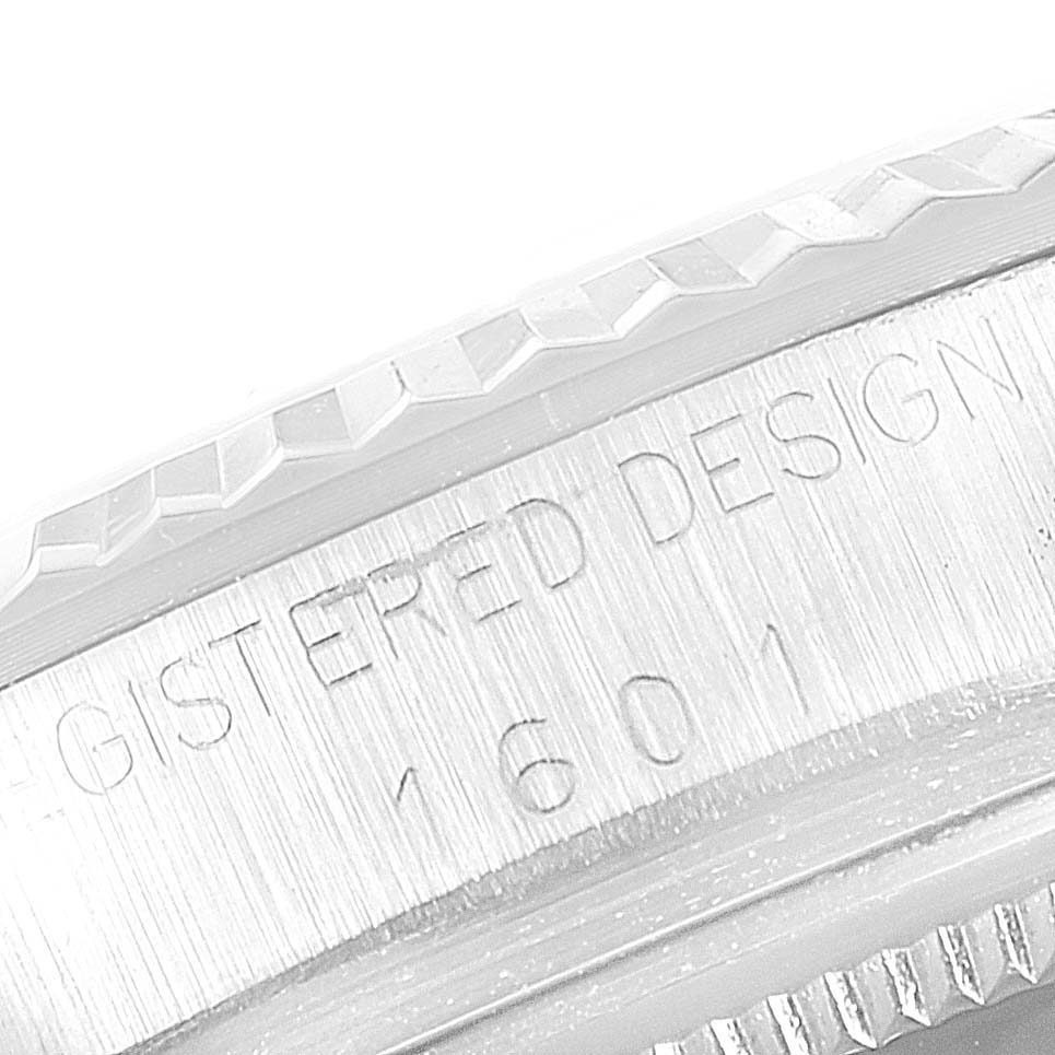 The close-up image shows the engraved details on the bezel and side of the Rolex Vintage Collection 1601 Men's Stainless Steel Silver Dial 1601 Men's Stainless Steel Silver Dial watch.