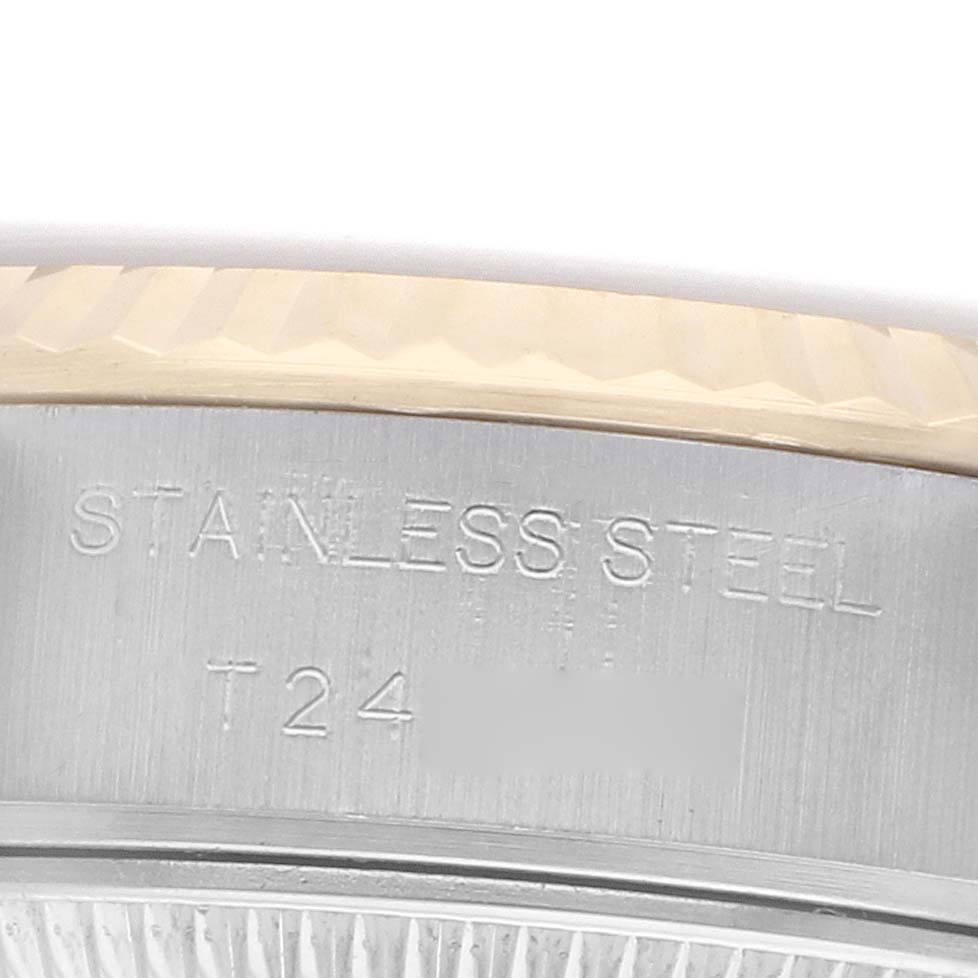 The image shows a close-up of the bezel and case side with engravings on a Rolex Datejust 69173 Women's Steel and Gold (two tone) Champagne Dial watch.