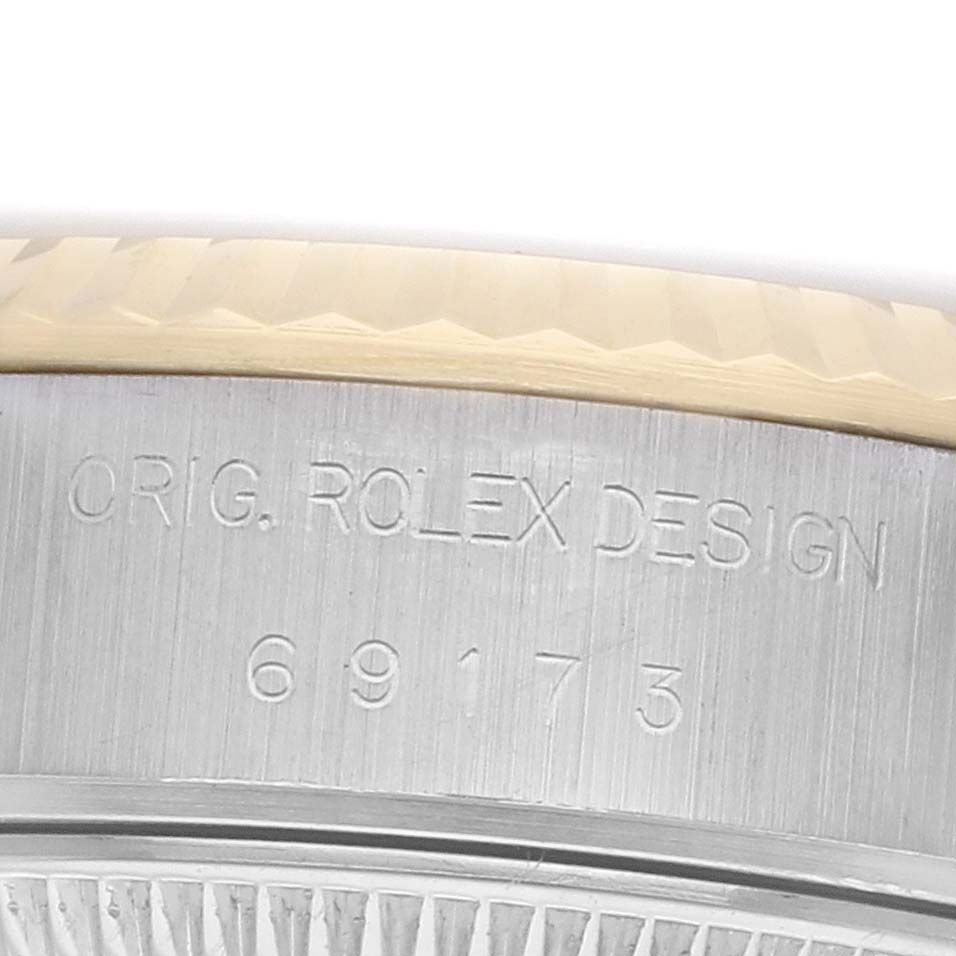 The image shows a close-up of the case side of a Rolex Datejust 69173 Women's Steel and Gold (two tone) Champagne Dial, highlighting the engraved model number and "ORIG. ROLEX DESIGN."