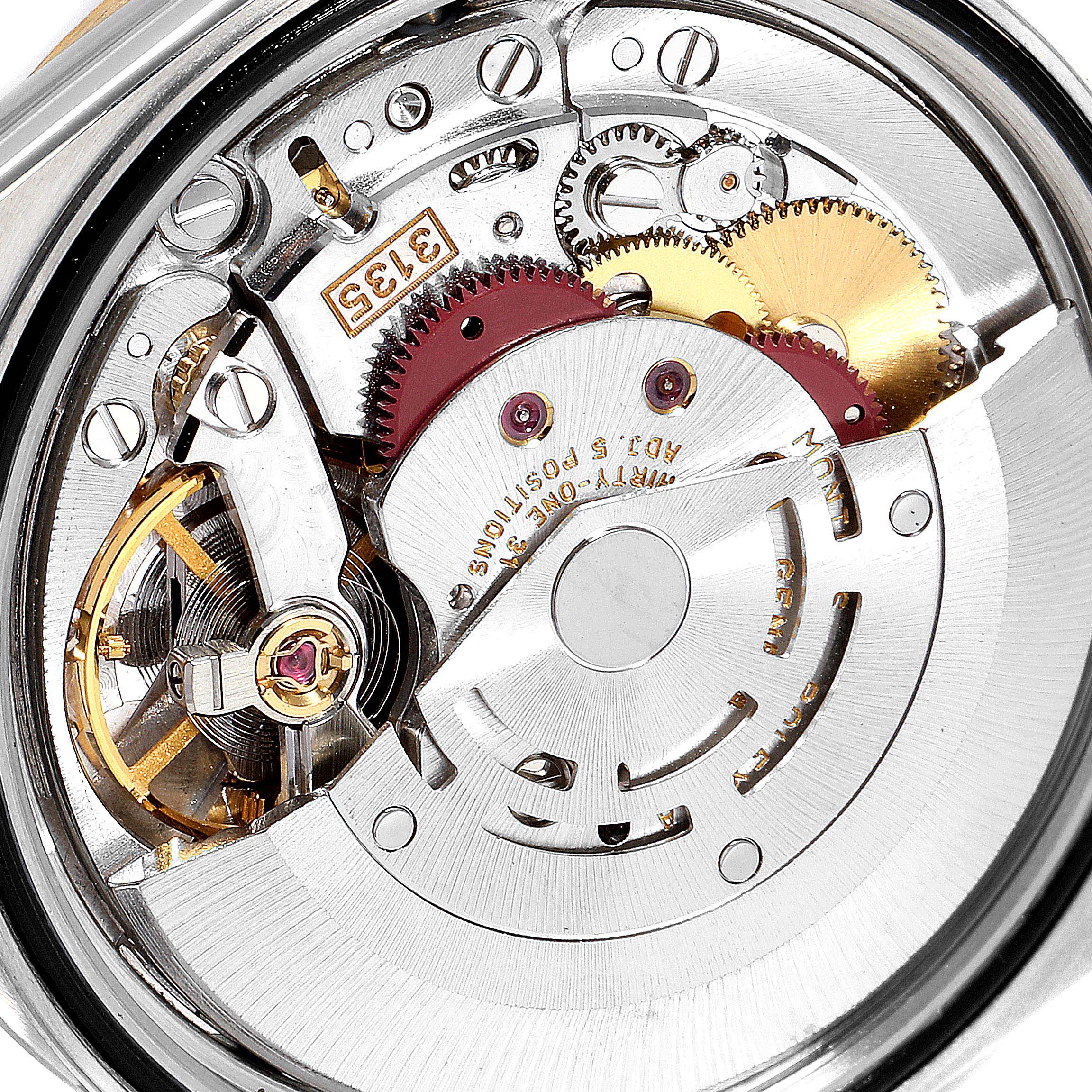 The image shows the internal mechanism of a Rolex Datejust 16233 Men's Steel and Gold (two tone) Blue Dial 16233 Men's Steel and Gold (two tone) Blue Dial watch at a close-up angle, highlighting gears and movement.