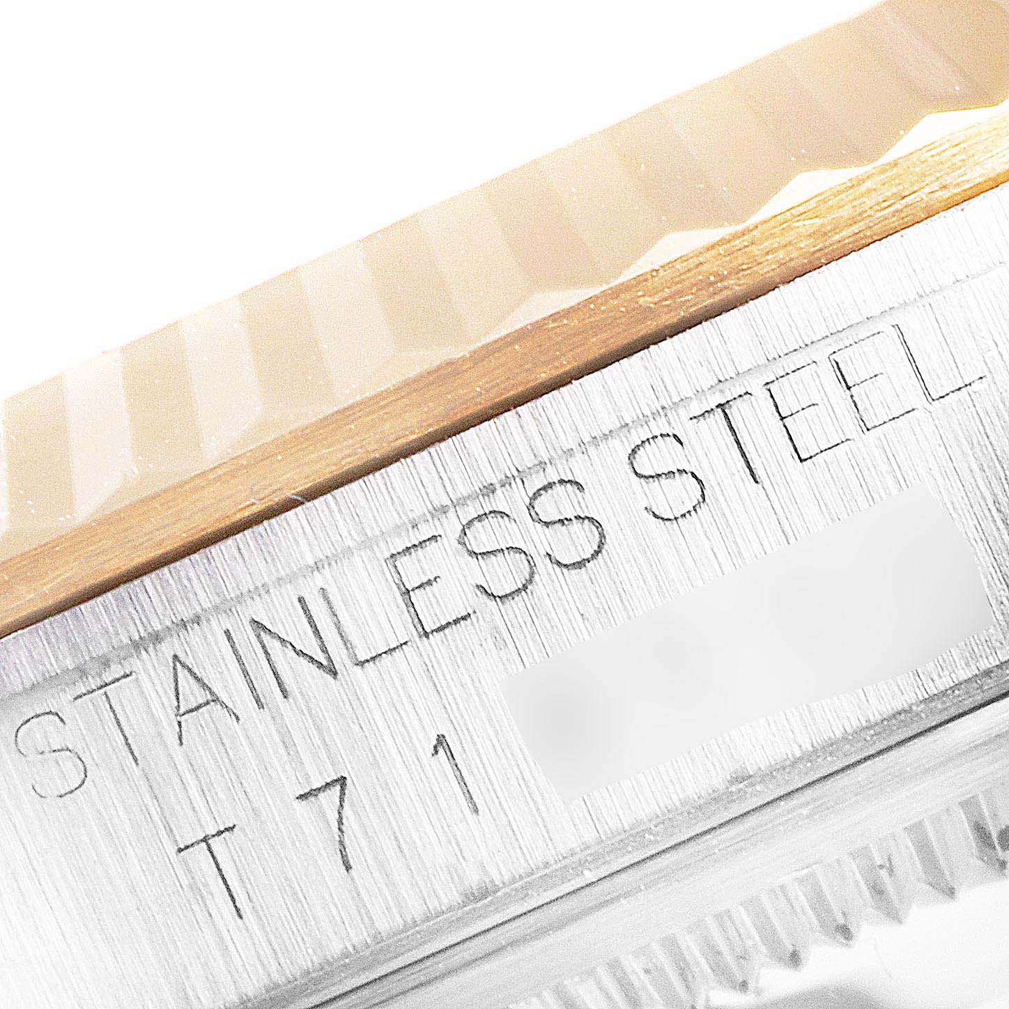 The image shows a close-up of the fluted bezel and case edge of a Rolex Datejust 16233 Men's Steel and Gold (two tone) Blue Dial 16233 Men's Steel and Gold (two tone) Blue Dial model, highlighting the "STAINLESS STEEL" inscription.