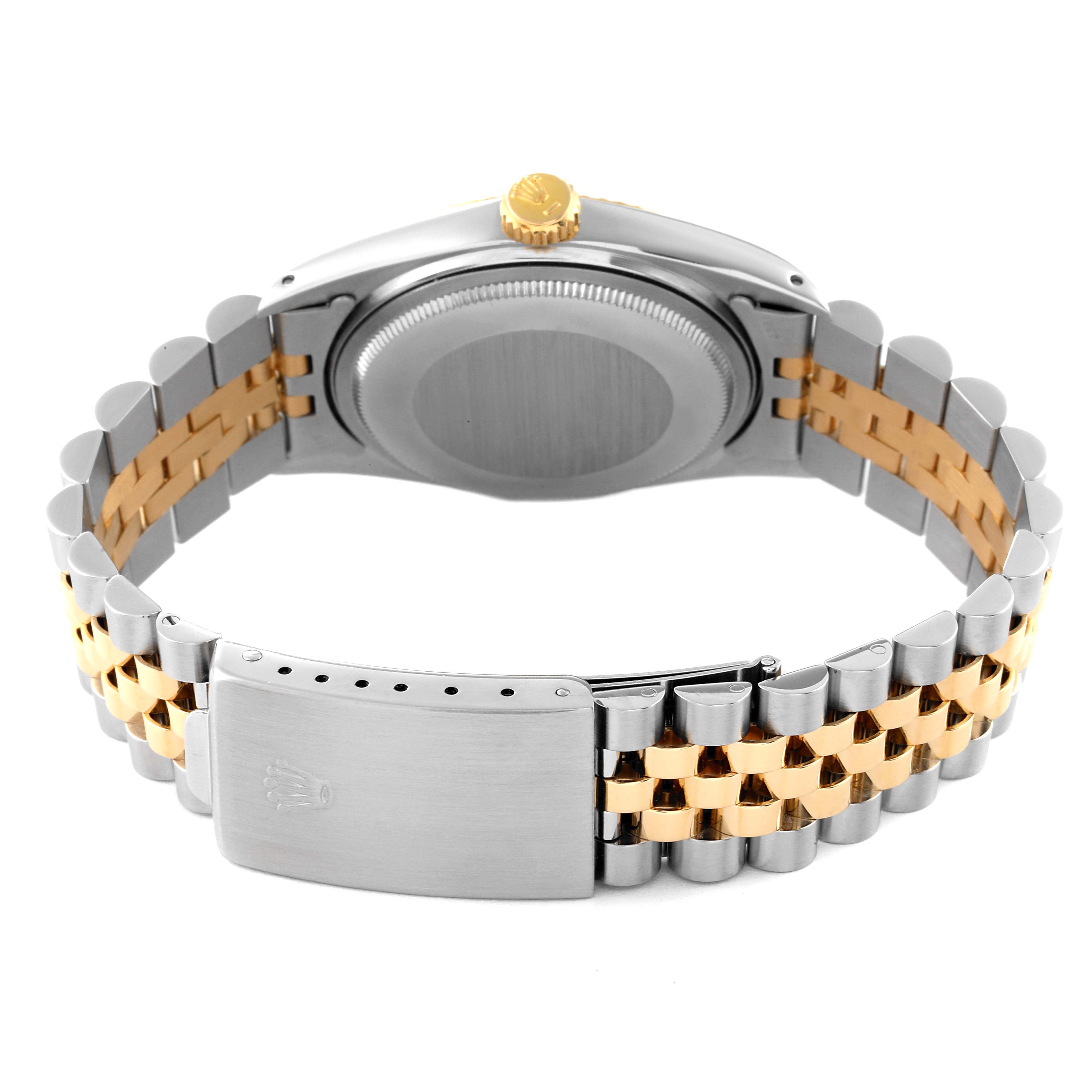 The image shows the Rolex Vintage Collection 16013 Men's Steel and Gold (two tone) Champagne Dial 16013 Men's Steel and Gold (two tone) Champagne Dial watch's back and clasp, featuring a silver and gold bracelet.