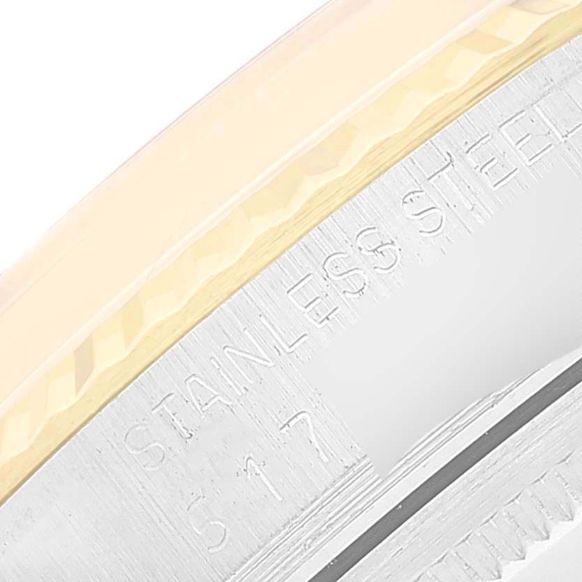 This image shows a close-up of the side of a Vintage Collection Rolex watch, highlighting the stainless steel and serial number engraving.