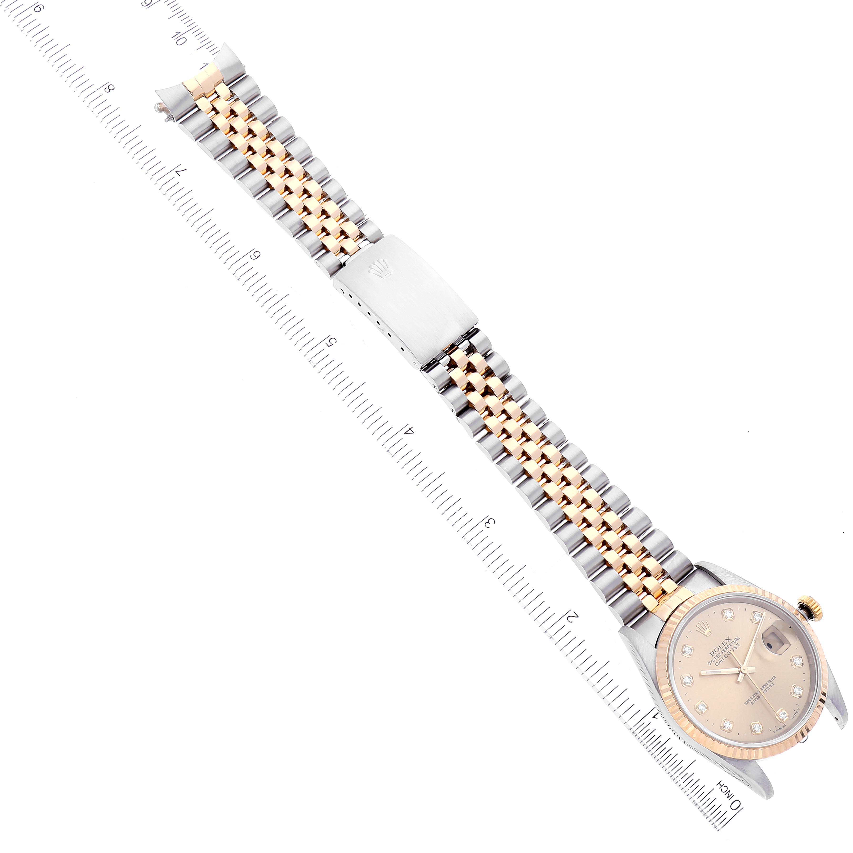 The Rolex Datejust 16233 Men's Steel and Gold (two tone) Champagne Dial 16233 Men's Steel and Gold (two tone) Champagne Dial watch shown is positioned flat with its full bracelet visible, accompanied by a ruler for measurement.