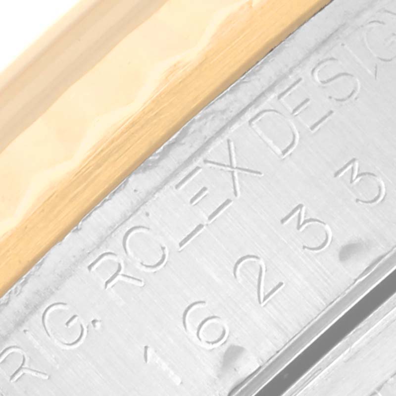 This close-up image shows part of the side of a Rolex Datejust 16233 Men's Steel and Gold (two tone) Champagne Dial 16233 Men's Steel and Gold (two tone) Champagne Dial watch, highlighting the inscription and bezel.