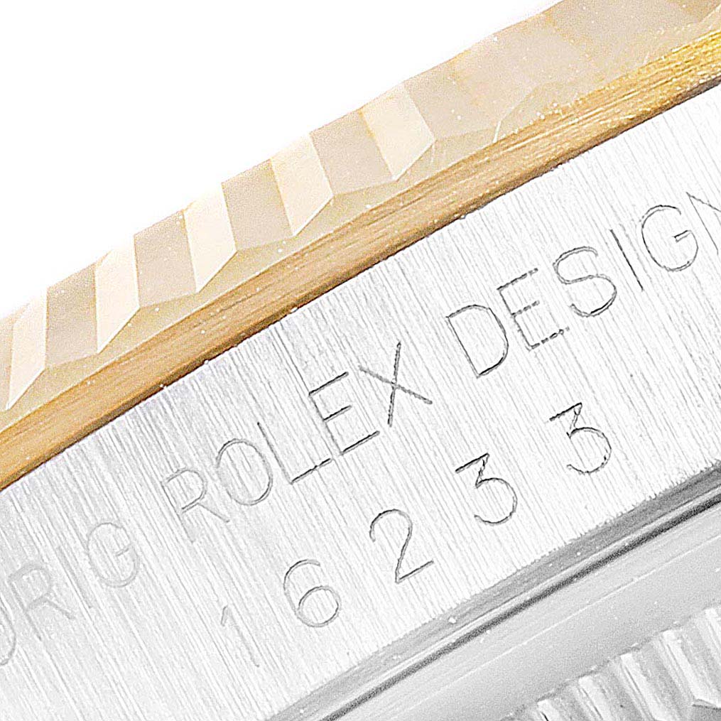 The image shows a close-up angle of the bezel and case side of the Rolex Datejust 16233 Men's Steel and Gold (two tone) Blue Dial 16233 Men's Steel and Gold (two tone) Blue Dial watch, featuring engraved text and model number 16233.