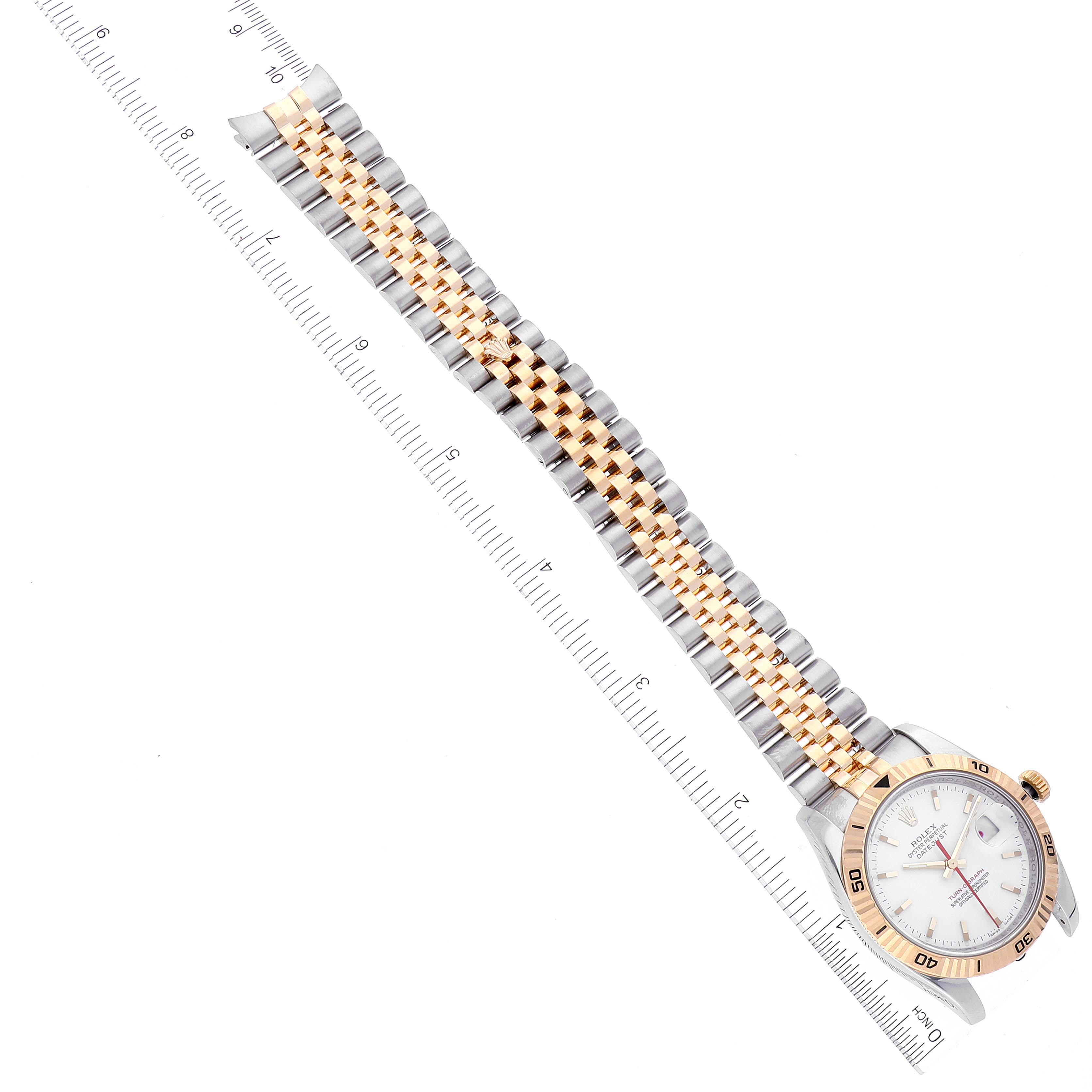 The Rolex Turn-o-Graph 116263 Men's Steel and Gold (two tone) White Dial 116263 Men's Steel and Gold (two tone) White Dial watch is shown at an angle displaying the face and the entire two-tone bracelet alongside a ruler.
