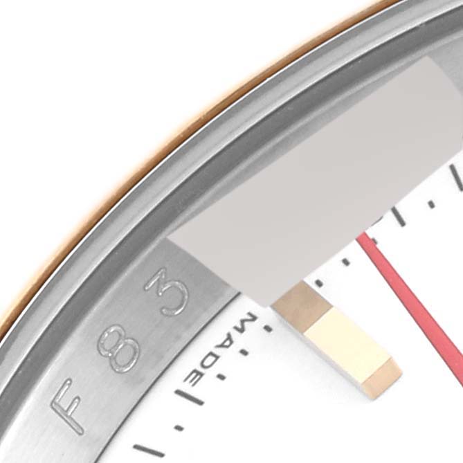This close-up image of a Rolex Turn-o-Graph 116263 Men's Steel and Gold (two tone) White Dial 116263 Men's Steel and Gold (two tone) White Dial watch shows part of the bezel with engravings and the "MADE" text on the dial.