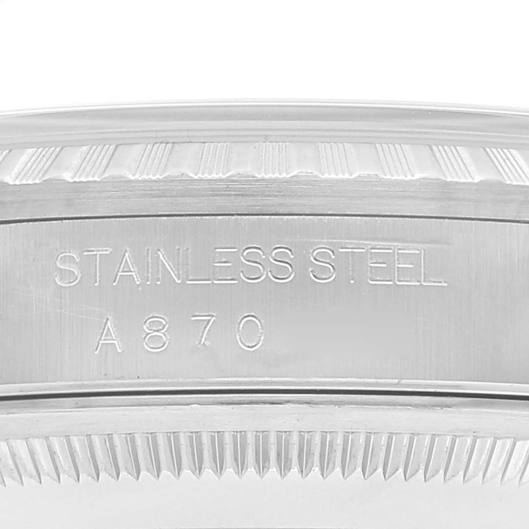 This close-up image shows the stainless steel engravings on the bezel of a Rolex Datejust 16220 Men's Stainless Steel White Dial 16220 Men's Stainless Steel White Dial watch.