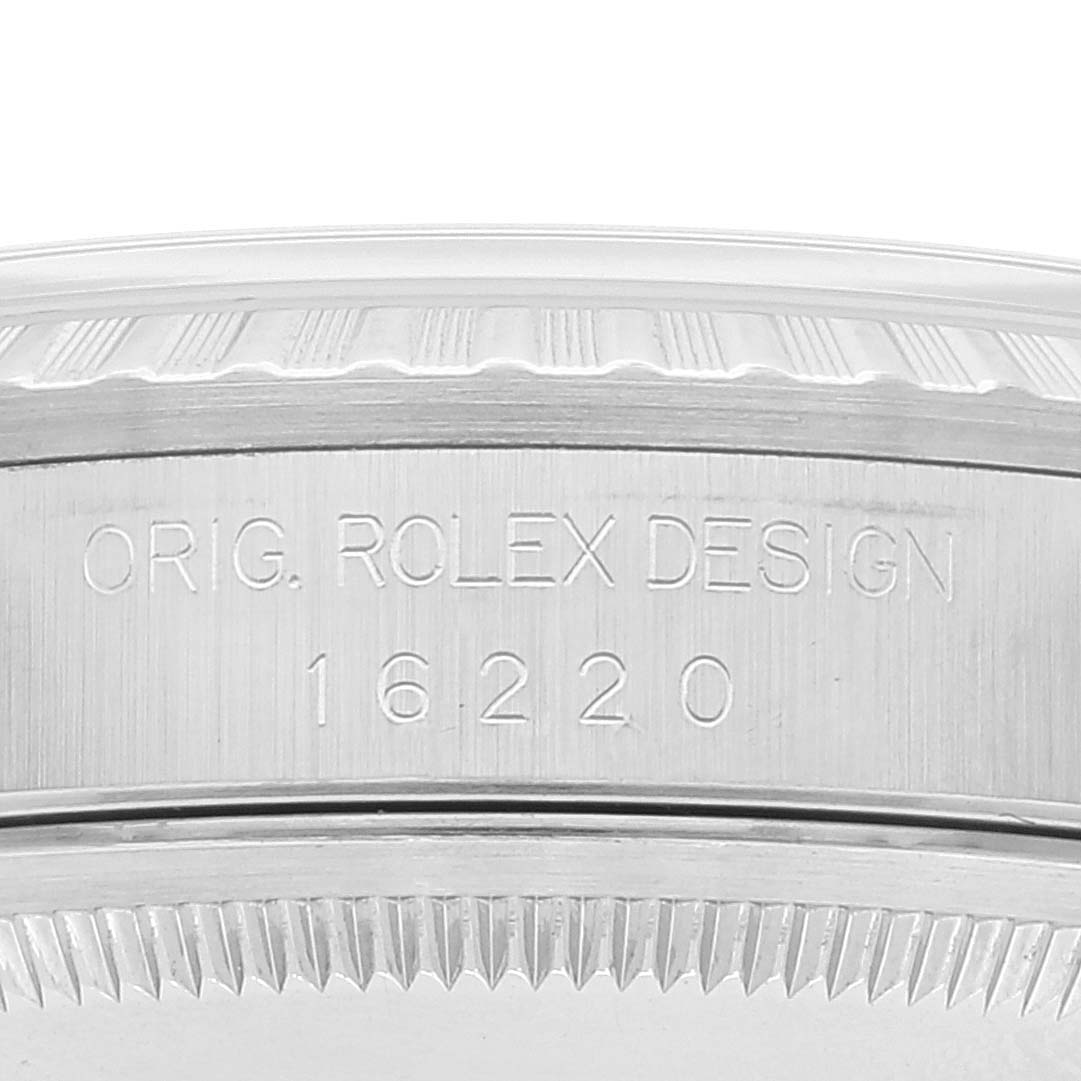 This image shows a close-up of the side of a Rolex Datejust 16220 Men's Stainless Steel White Dial 16220 Men's Stainless Steel White Dial model, featuring the engraved "ORIG. ROLEX DESIGN 16220."