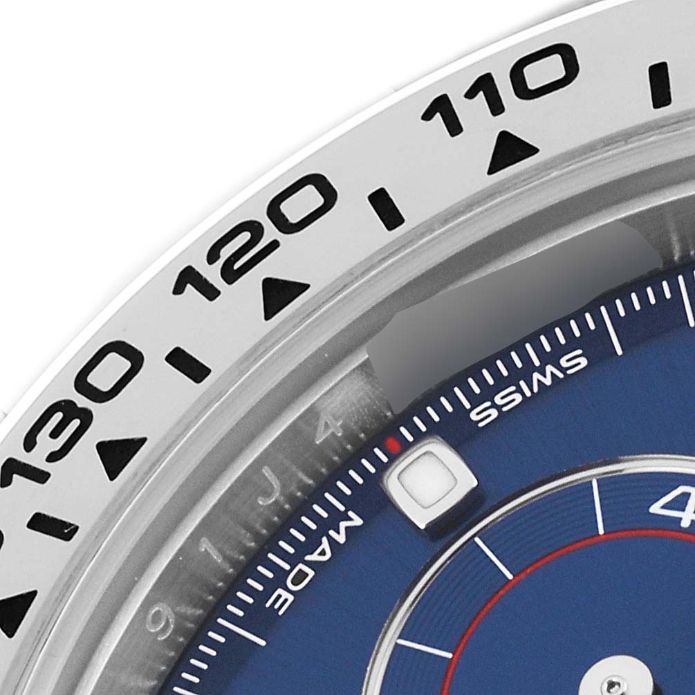 This close-up image shows the tachymeter bezel and part of the dial of the Rolex Daytona 116509 Men's White Gold Blue Dial 116509 Men's White Gold Blue Dial watch.