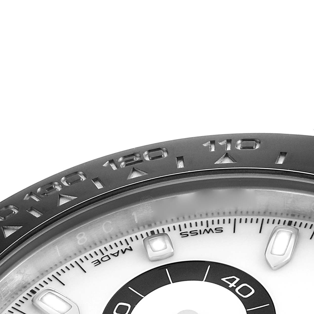 The image shows a close-up of the bezel and part of the dial of a Rolex Daytona 116500 Men
s Stainless Steel White Dial, focusing on the tachymetric scale.