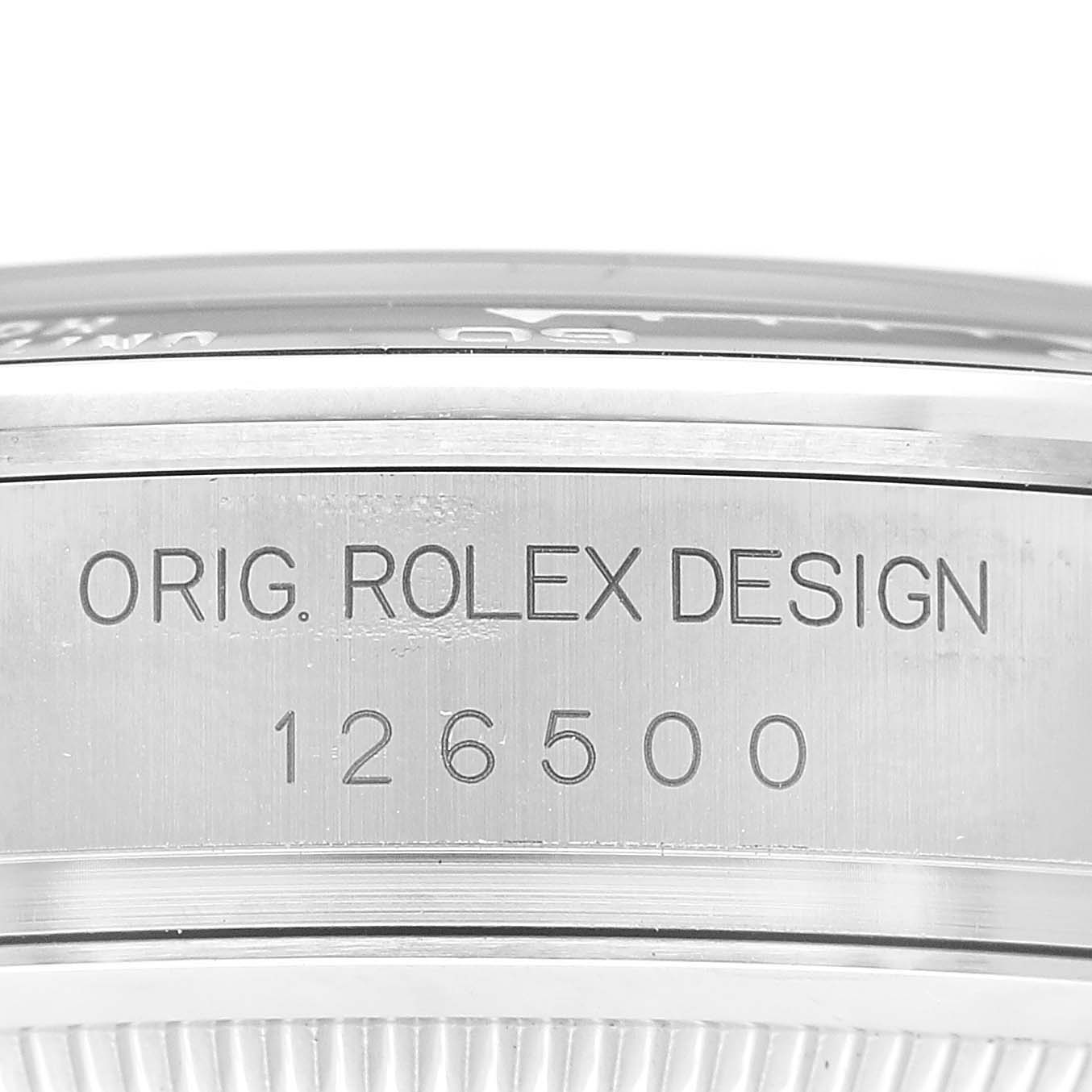 The image shows a close-up of the engraving on the side of a Rolex Daytona 126500 Men's Stainless Steel White Dial watch case, highlighting its design number.