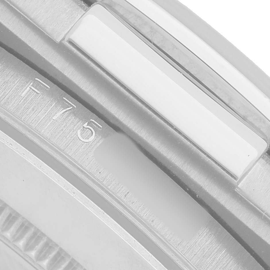 The image shows a close-up of the side profile of a Rolex Daytona 116519 Men's White Gold Silver Dial, highlighting the bezel and part of the case with engraved markings.