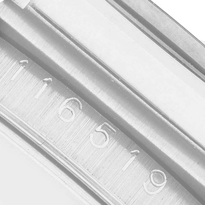 The image shows a close-up of the inner rehaut of a Rolex Daytona 116519 Men's White Gold Silver Dial, with engraved serial numbers visible.