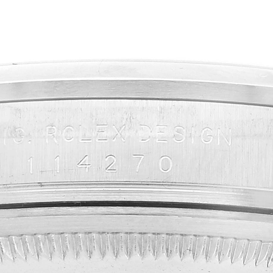This close-up image shows the engraved serial number and the edge of the case for a Rolex Explorer 114270 Men's Stainless Steel Black Dial 114270 Men's Stainless Steel Black Dial watch.