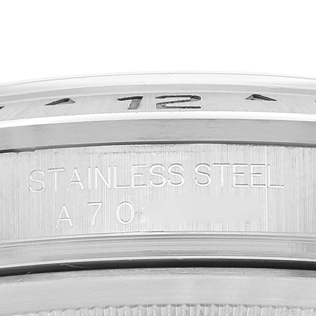 This image shows a close-up of the stainless steel bezel and serial number engraving on a Rolex Explorer 16570 Men's Stainless Steel White Dial 16570 Men's Stainless Steel White Dial watch.